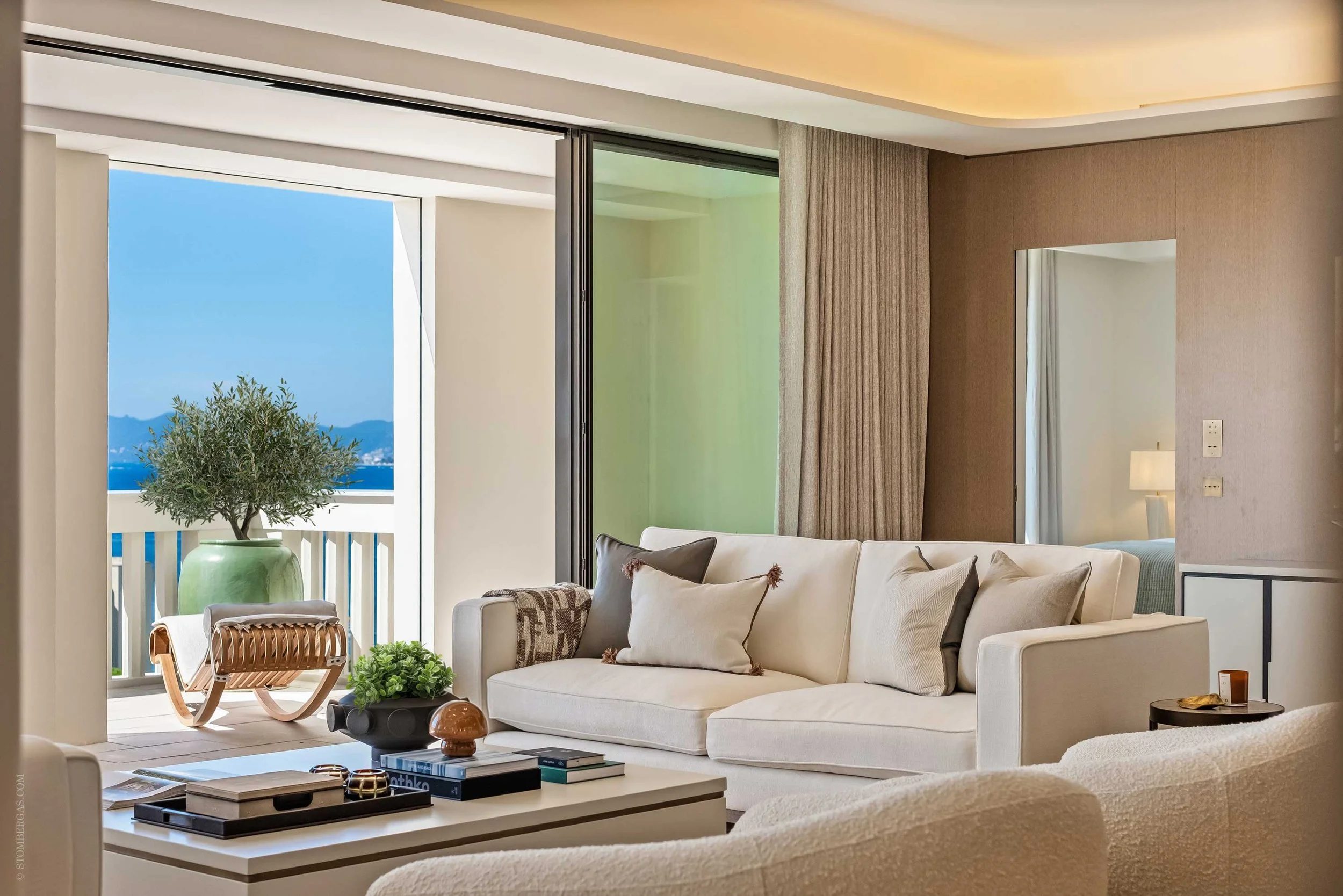 contemporary interior of cream sofas, coffee table and spectacular view out to the french riviera sea