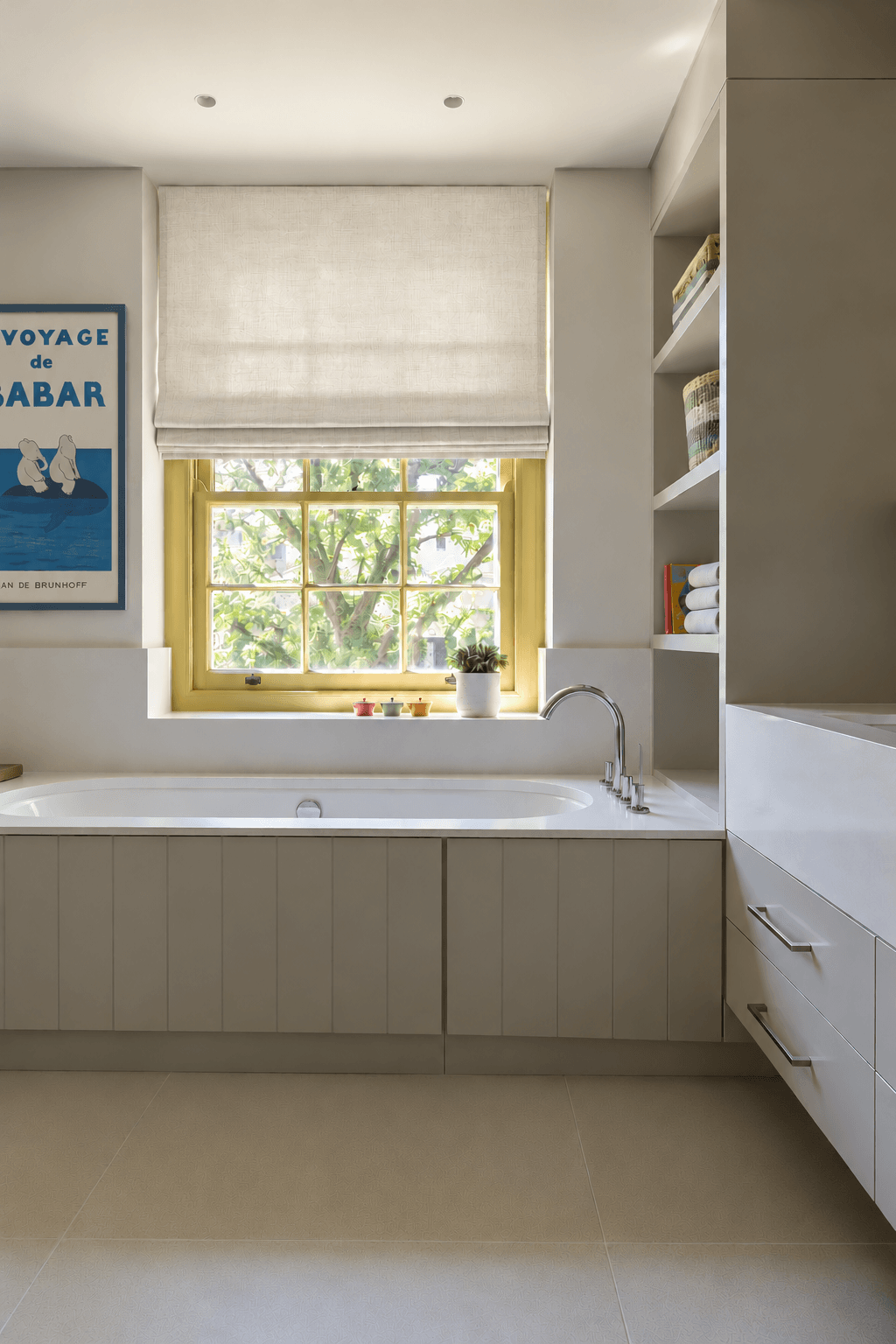children's bathroom with yellow window frame, linen blind and decoartive family friendly artwork in dark blue frame