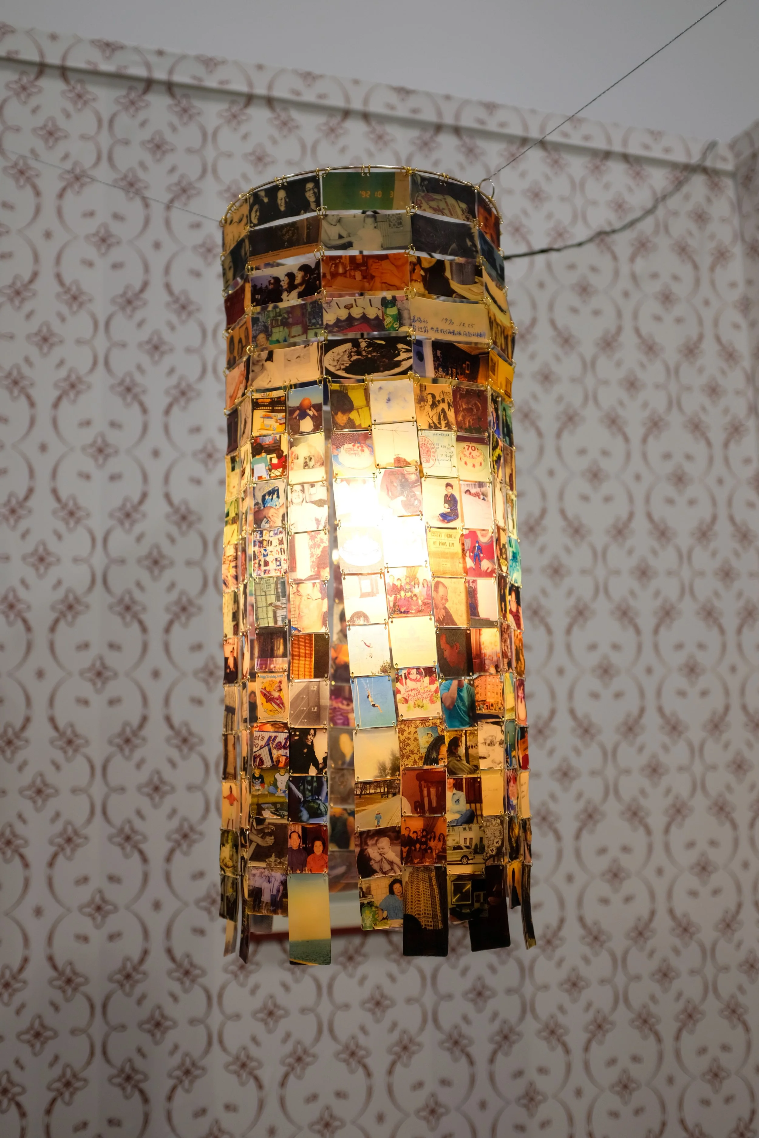 Reconstructing, 2026. Inkjet on shrink plastic, o-rings, single light fixture. 12 inches x 12 inches x 24 inches.