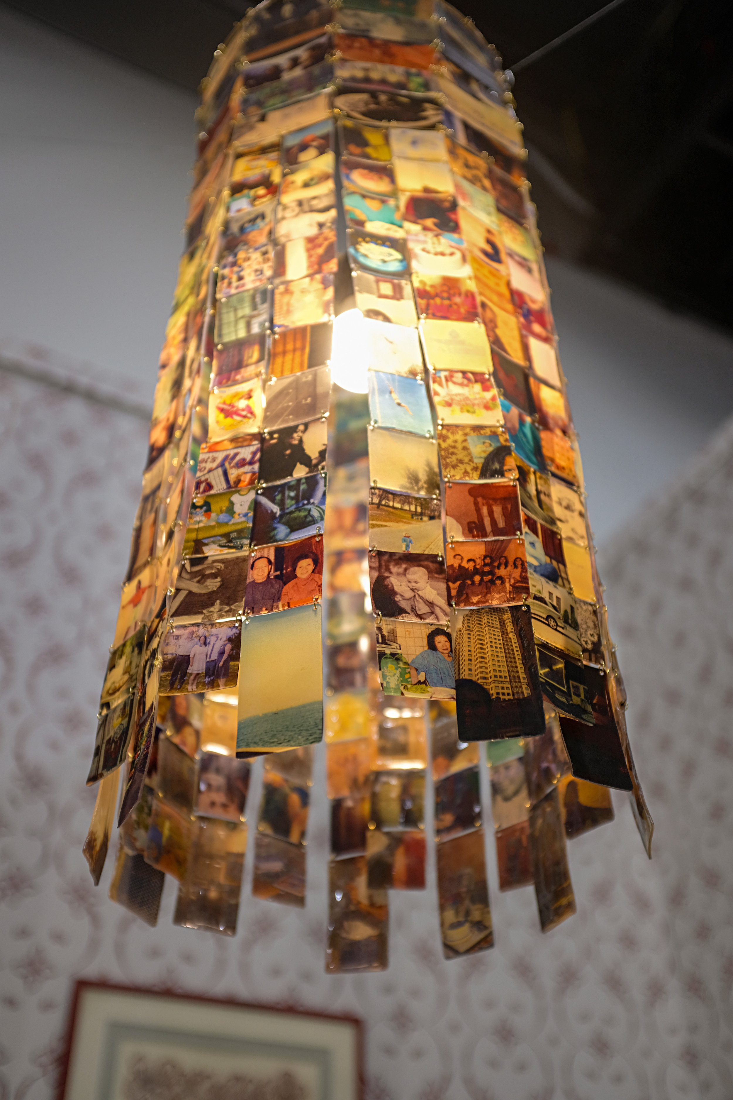 Reconstructing, 2026. Inkjet on shrink plastic, o-rings, single light fixture. 12 inches x 12 inches x 24 inches.