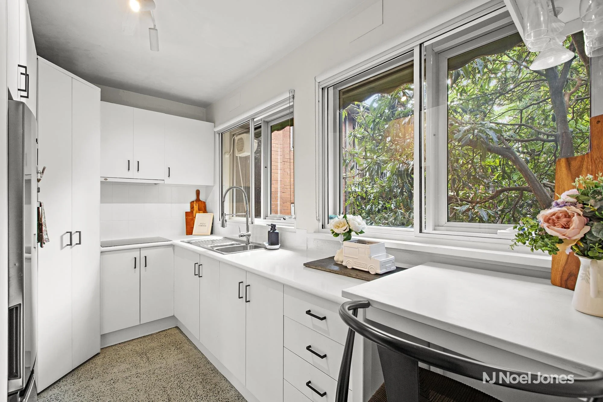 Spacious kitchen and living area at 13/88-92 Victoria Road showcasing natural light, quality fixtures, and leafy outlook. Ideally positioned between Camberwell and Hawthorn stations for easy Melbourne CBD access.