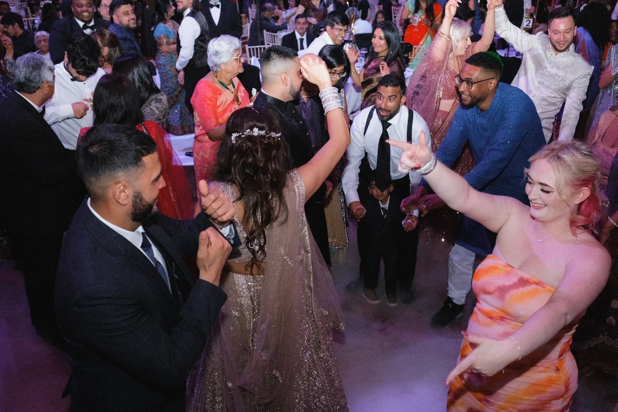 Group of people dancing and celebrating at a lively party or event.