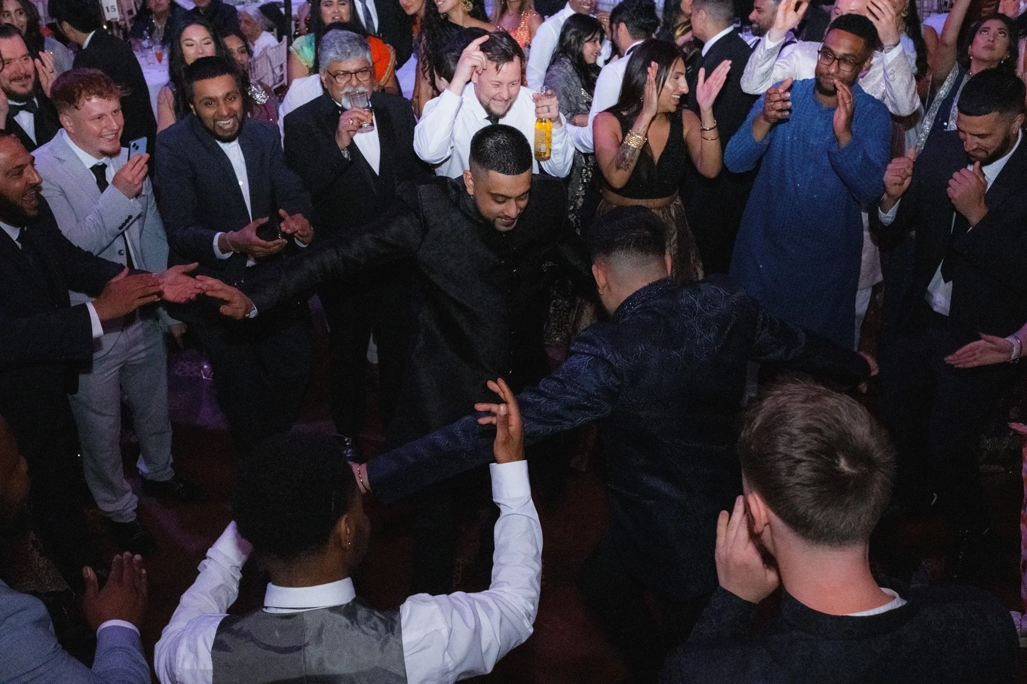Group of people dancing and celebrating at a party.