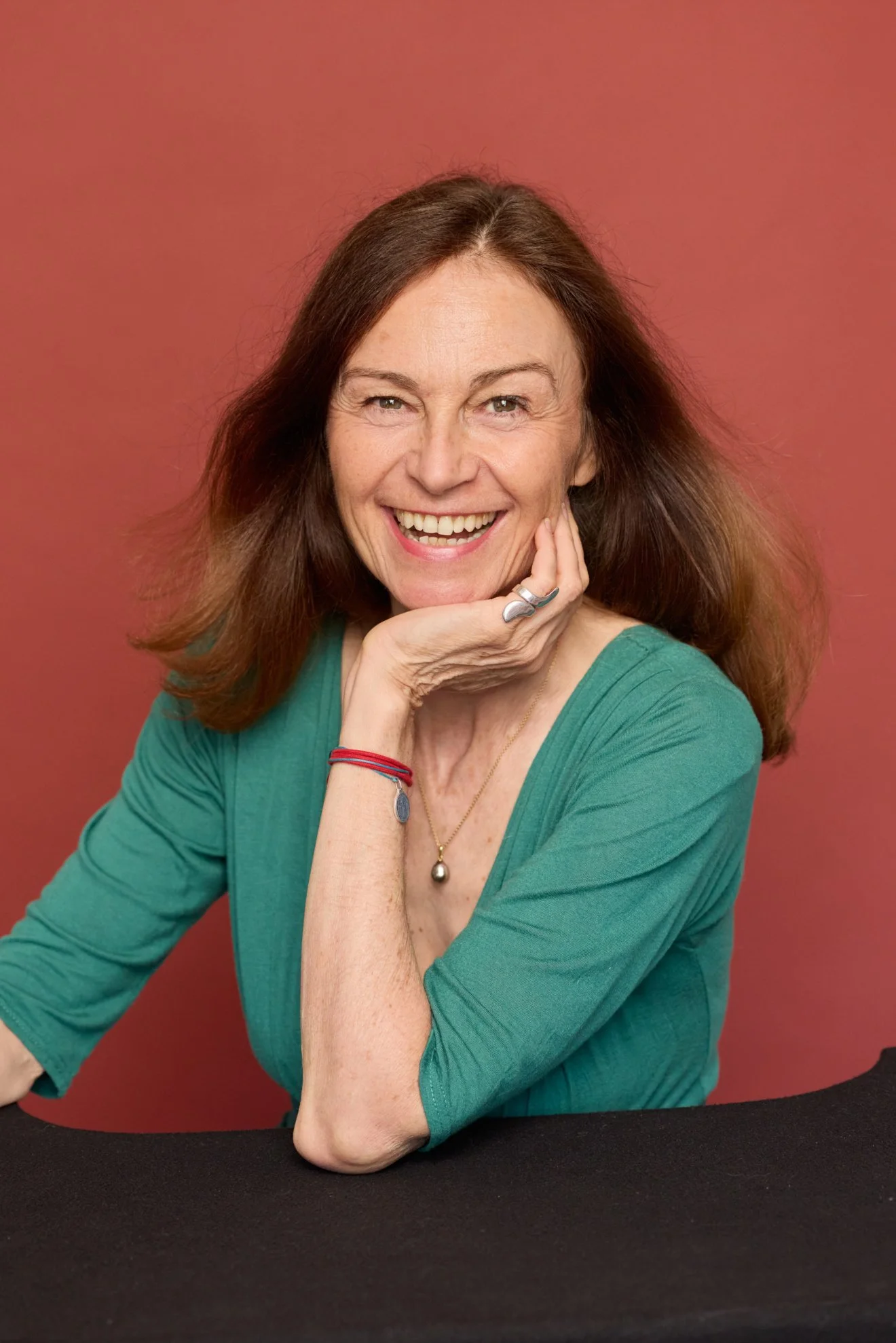 Pascale Brousse, founder of Trend Sourcing, wearing green against a terracotta background.