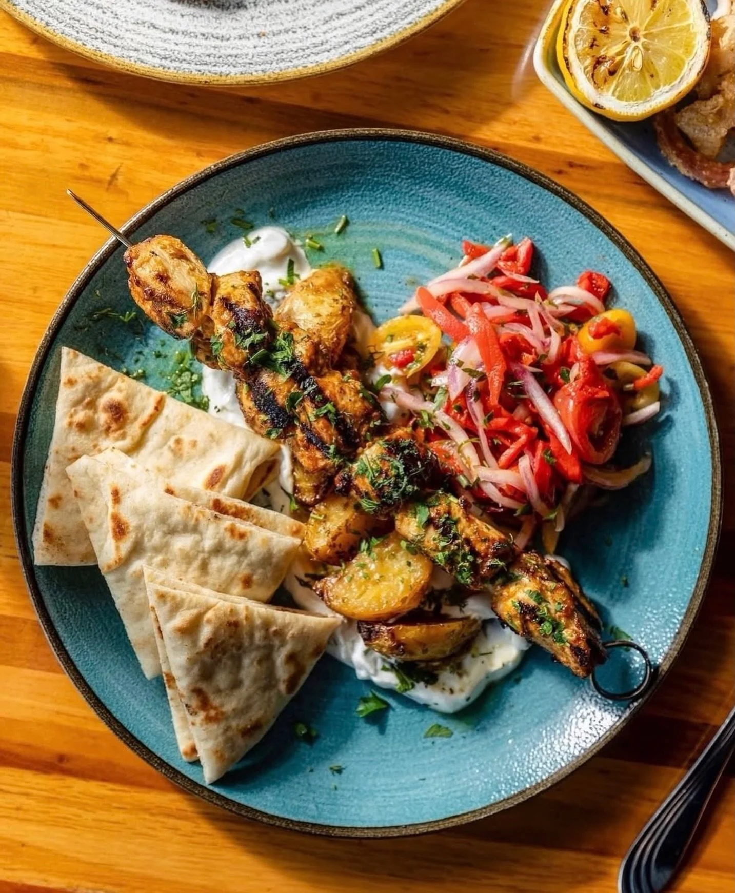 🌞 All the flavors of the Mediterranean on one plate!

From fresh tzatziki and bright, zesty lemon potatoes to fresh tomato relish, toasted pita, and chargrilled chicken souvlaki &ndash; our Kebab Plate has it all!

View our menus, make reservations,