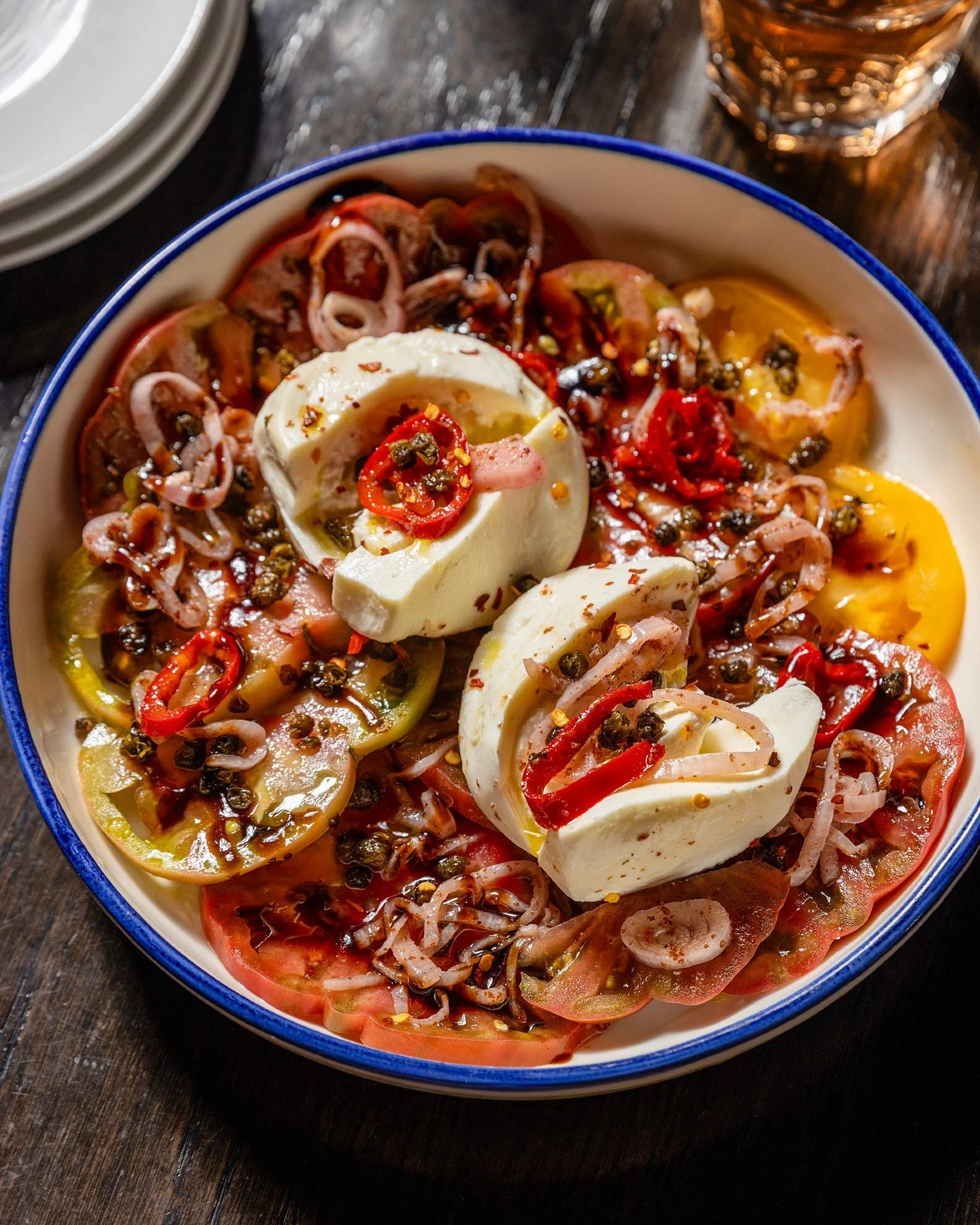 TOMATO &amp; BURRATA SALAD, new to the menu.

Heirloom tomatoes. Crispy capers. Pickled shallots. Pickled fresno chillies. Burrata cheese. Extra virgin olive oil. Balsamic.

Fresh tomatoes against cool, creamy burrata, with capers and pickled shallot