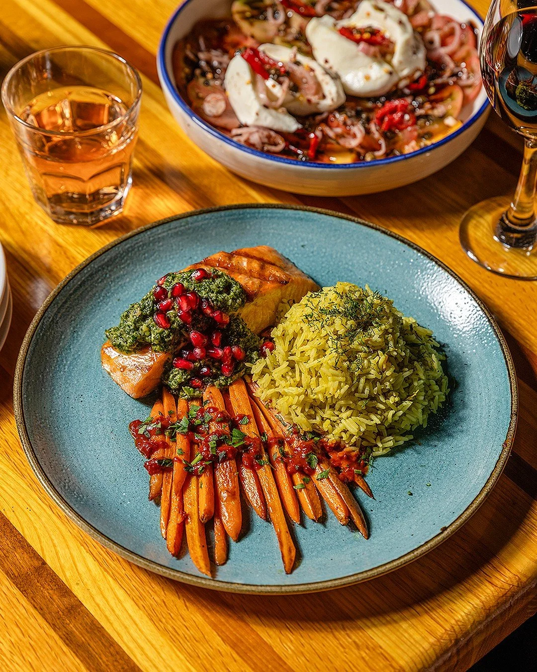Our salmon just got a delicious seasonal refresh.

Rich, buttery salmon brightened by tart sumac and pomegranate gremolata, the seeds sharp and tangy against fresh herbs. Golden herbed saffron rice. Sweet baby carrots with a touch of char.

On the me