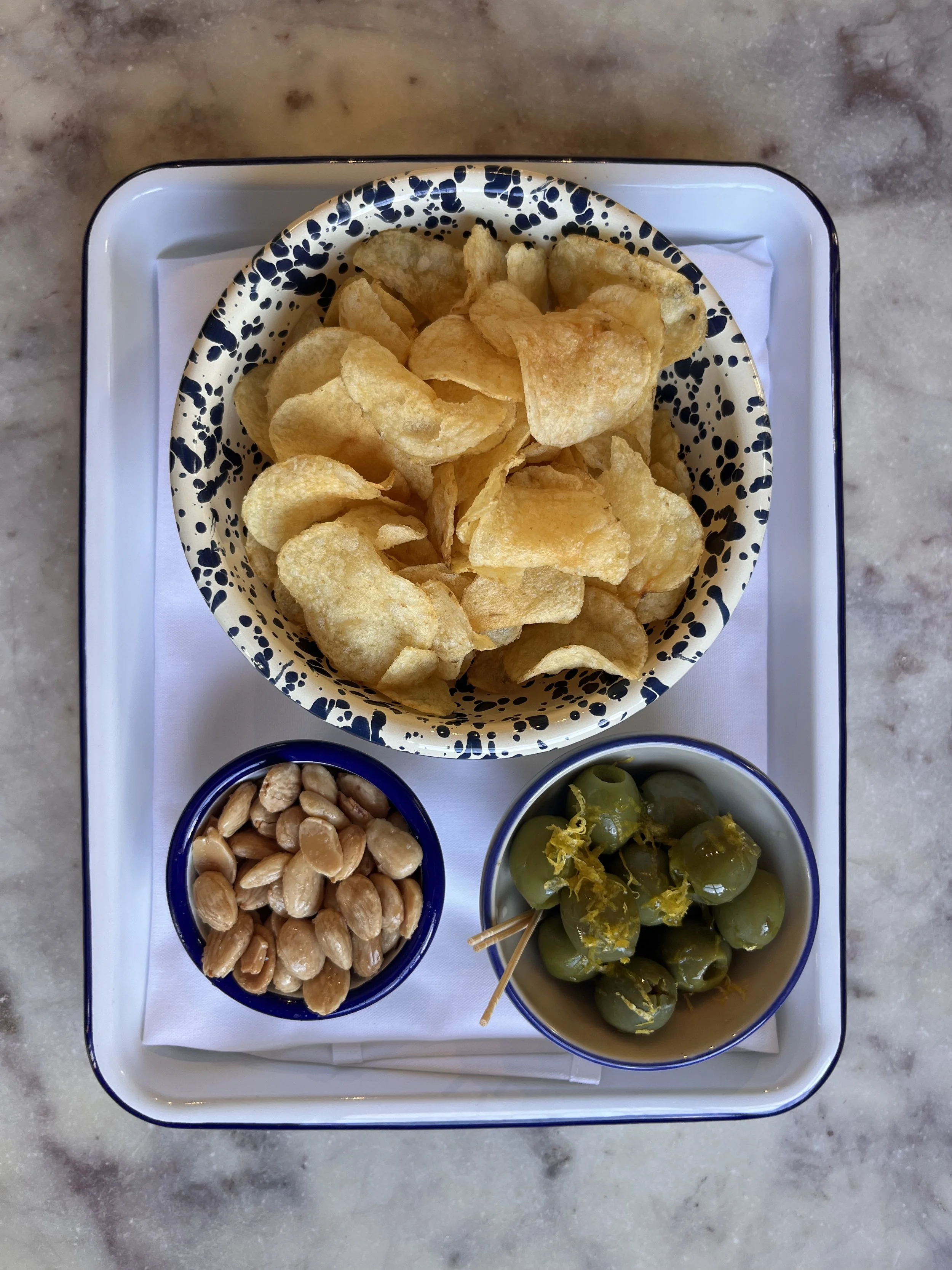 Mediterranean Trio: chips, olives, & almonds all in their usual bowls
