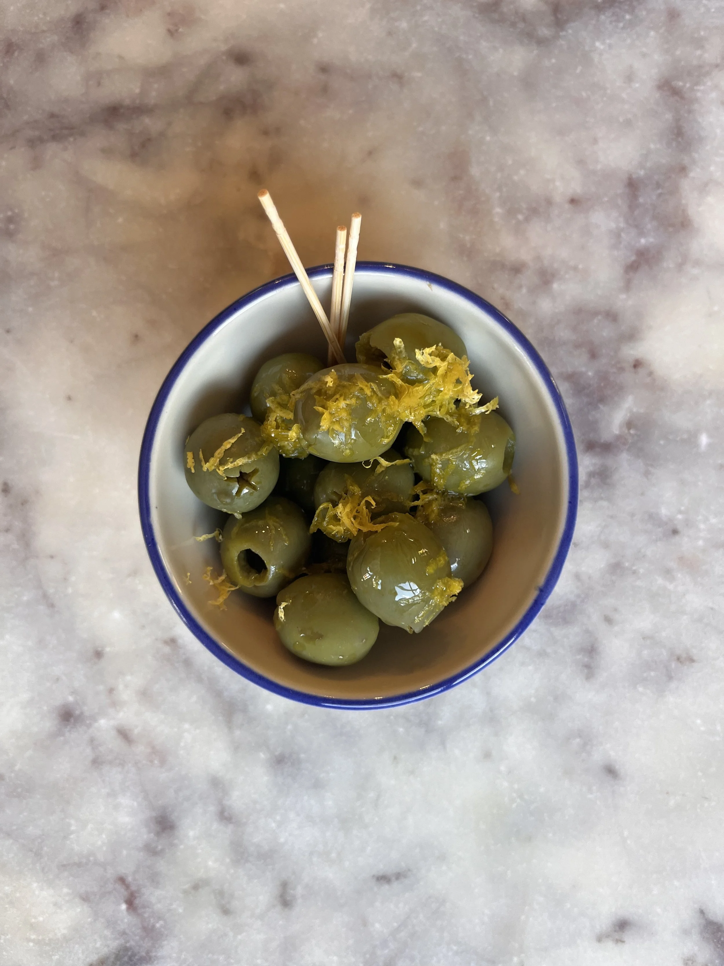 Olives: topped w/ lemon zest & olive oil filled to the rim but not over