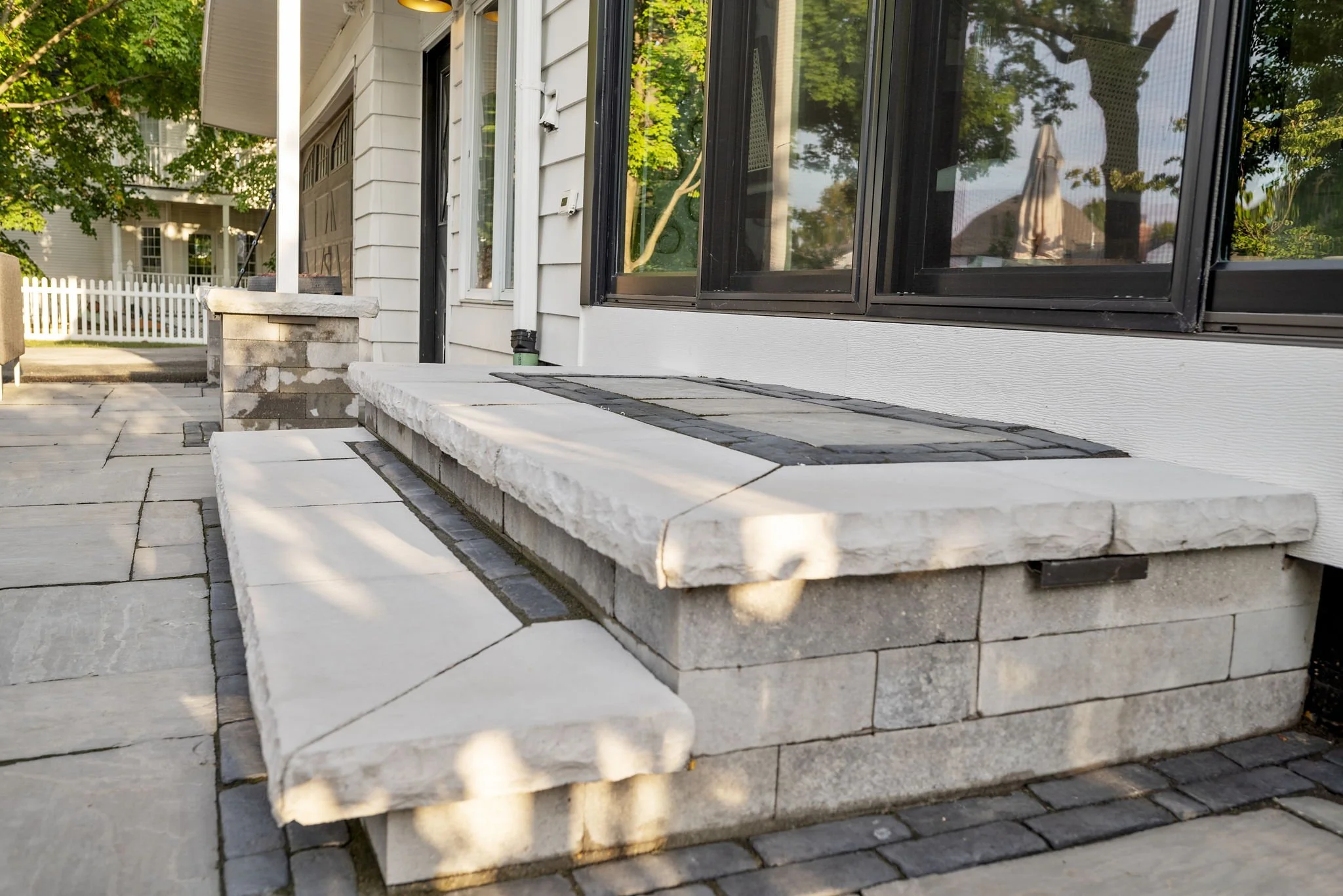 Custom paver lighted step from elevated back door at a historic property in Naperville, IL.