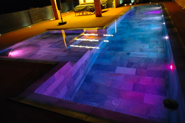 Modern pool and spa with integrated changing LED mood lights.