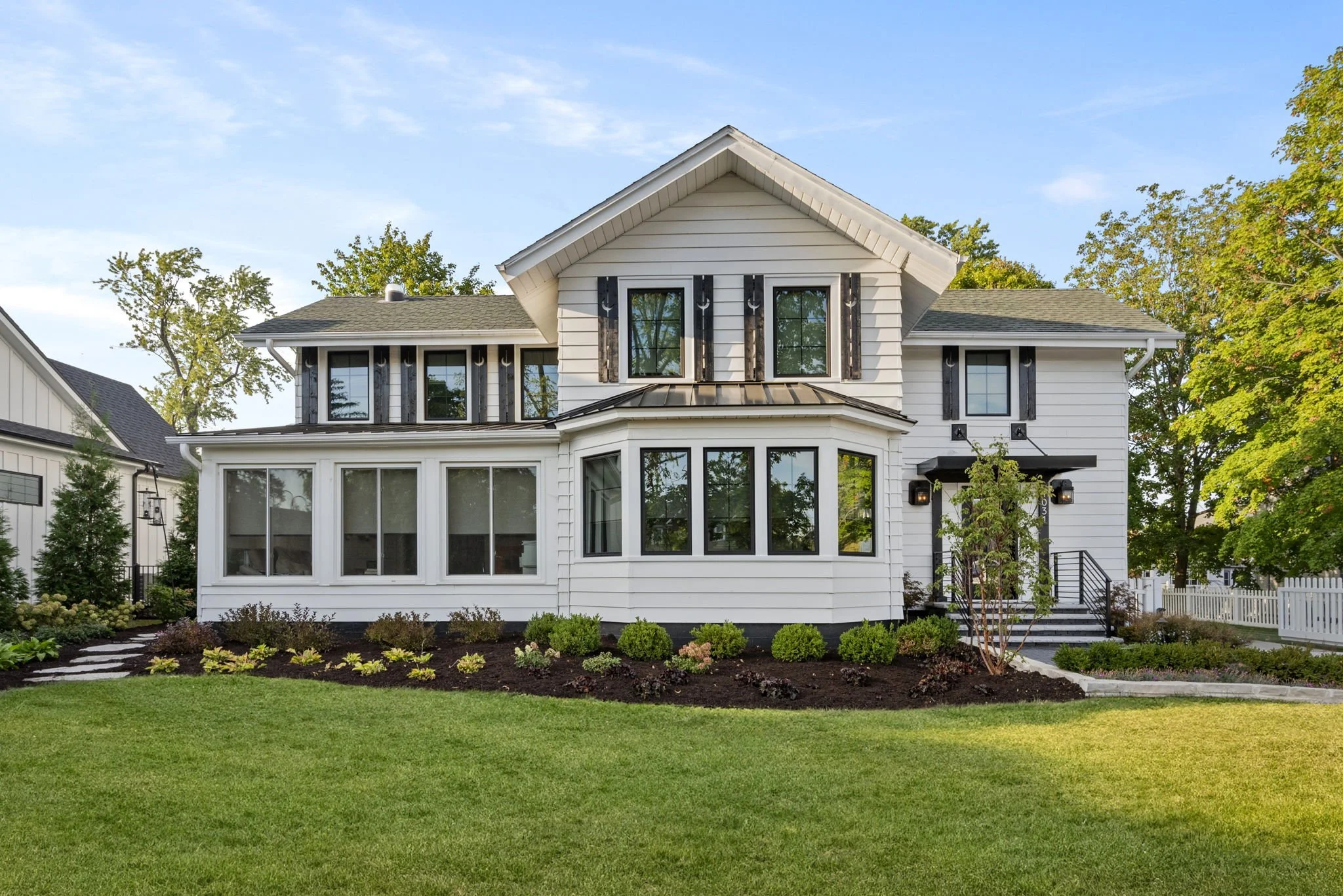 Front view of a historic home in Naperville offering garden design ideas.