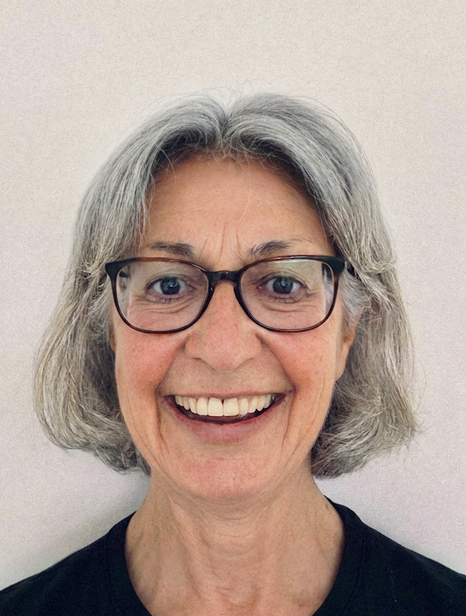 Smiling woman with gray hair and glasses