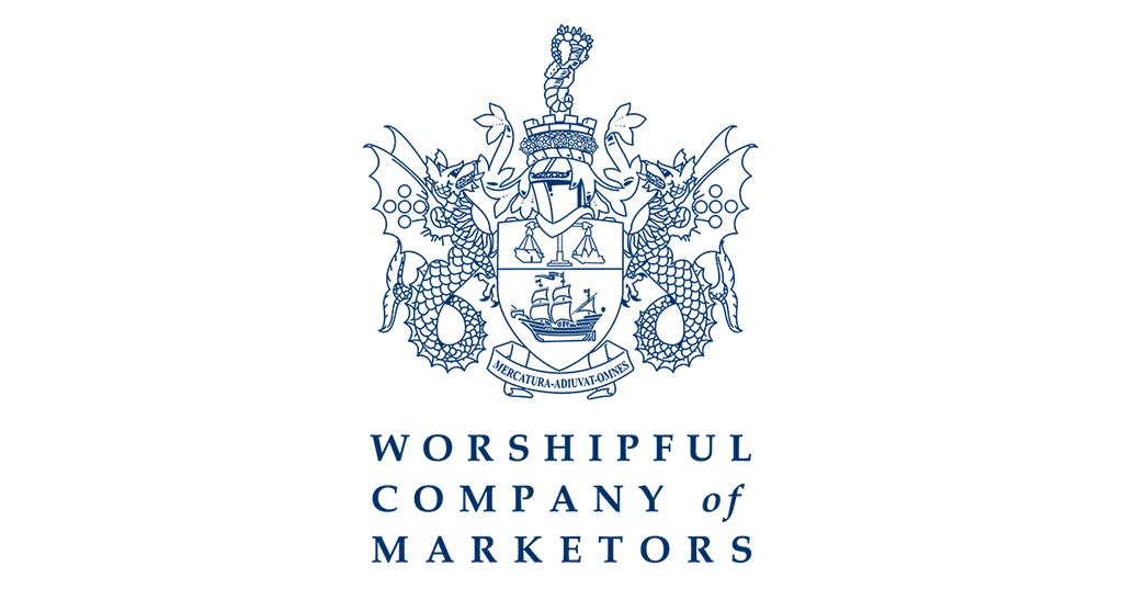A logo for Worshipful Company of Marketers featuring a detailed heraldic crest with a shield, two dragons, and a ship, accompanied by the text "WORSHIPFUL COMPANY of MARKETERS" underneath.
