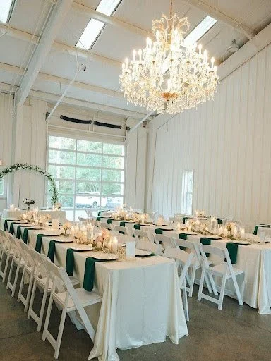 Wedding reception setup inside Lovegrove Estate featuring a crystal chandelier, banquet tables, and elegant décor.