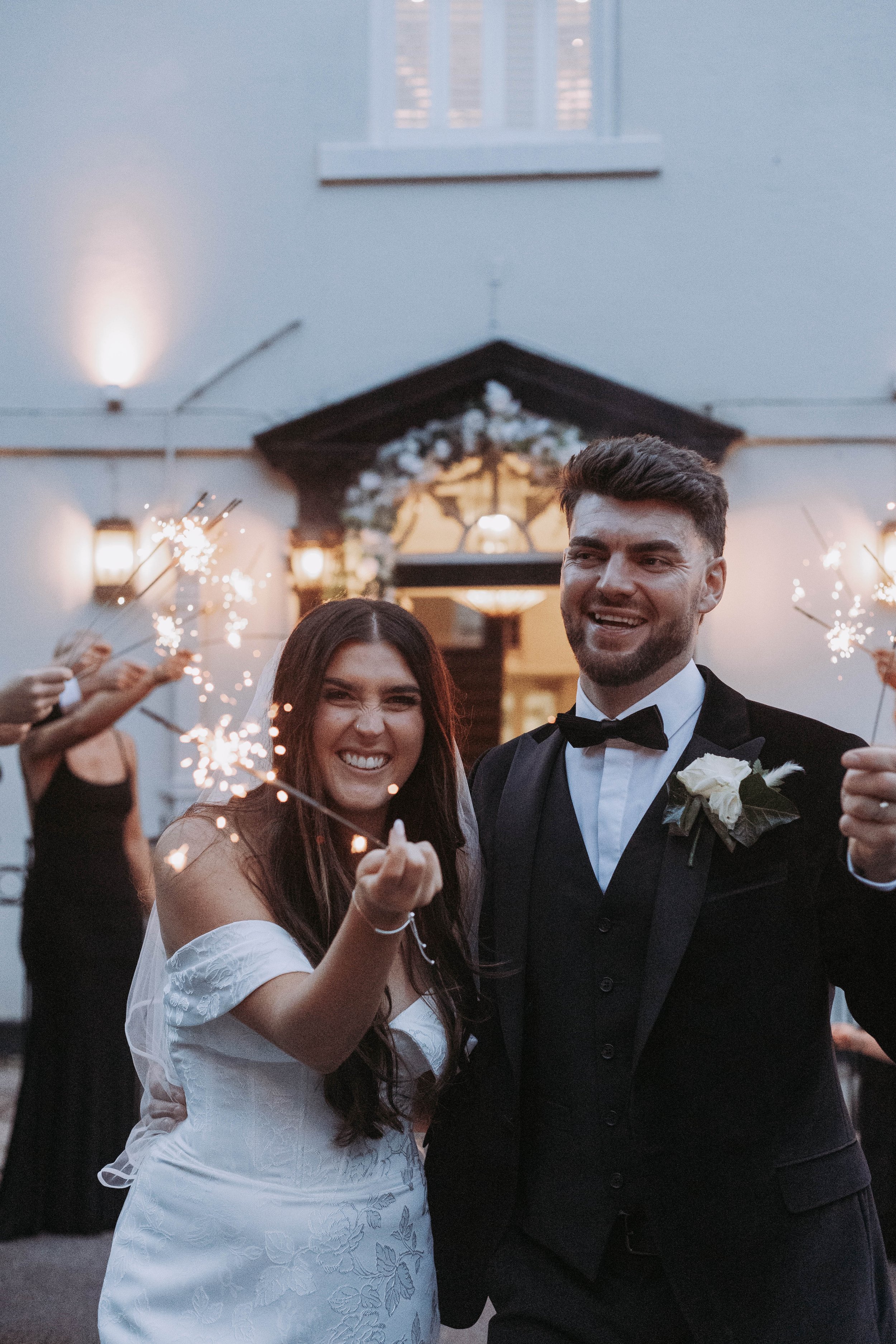 Bride and groom exiting Sparth House wedding venue Lancashire with sparkers