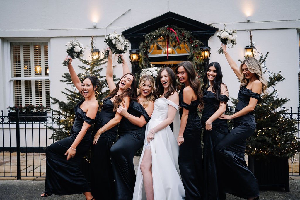 Bridesmaids having photographs outside of Sparth House