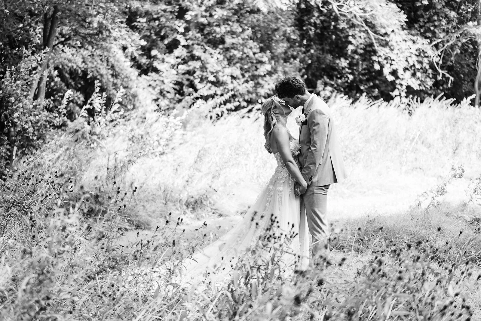 Newlyweds walking through gardens at Sparth House Lancashire wedding venue