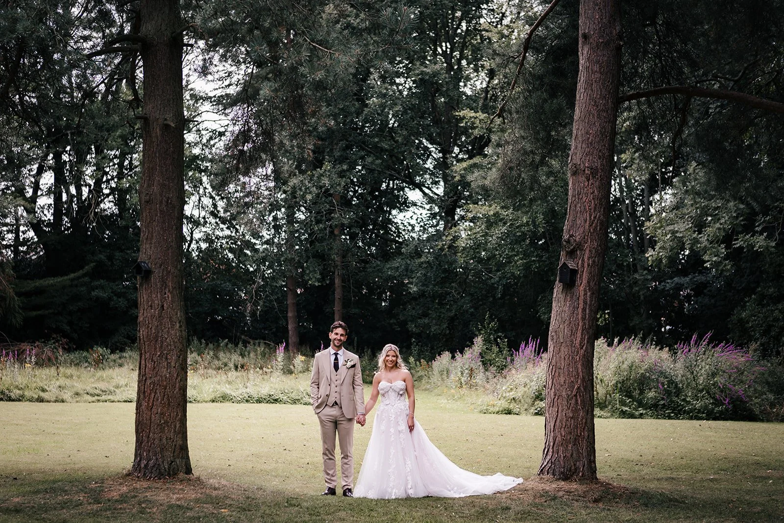 Bride smiling at groom during garden portraits at Sparth House