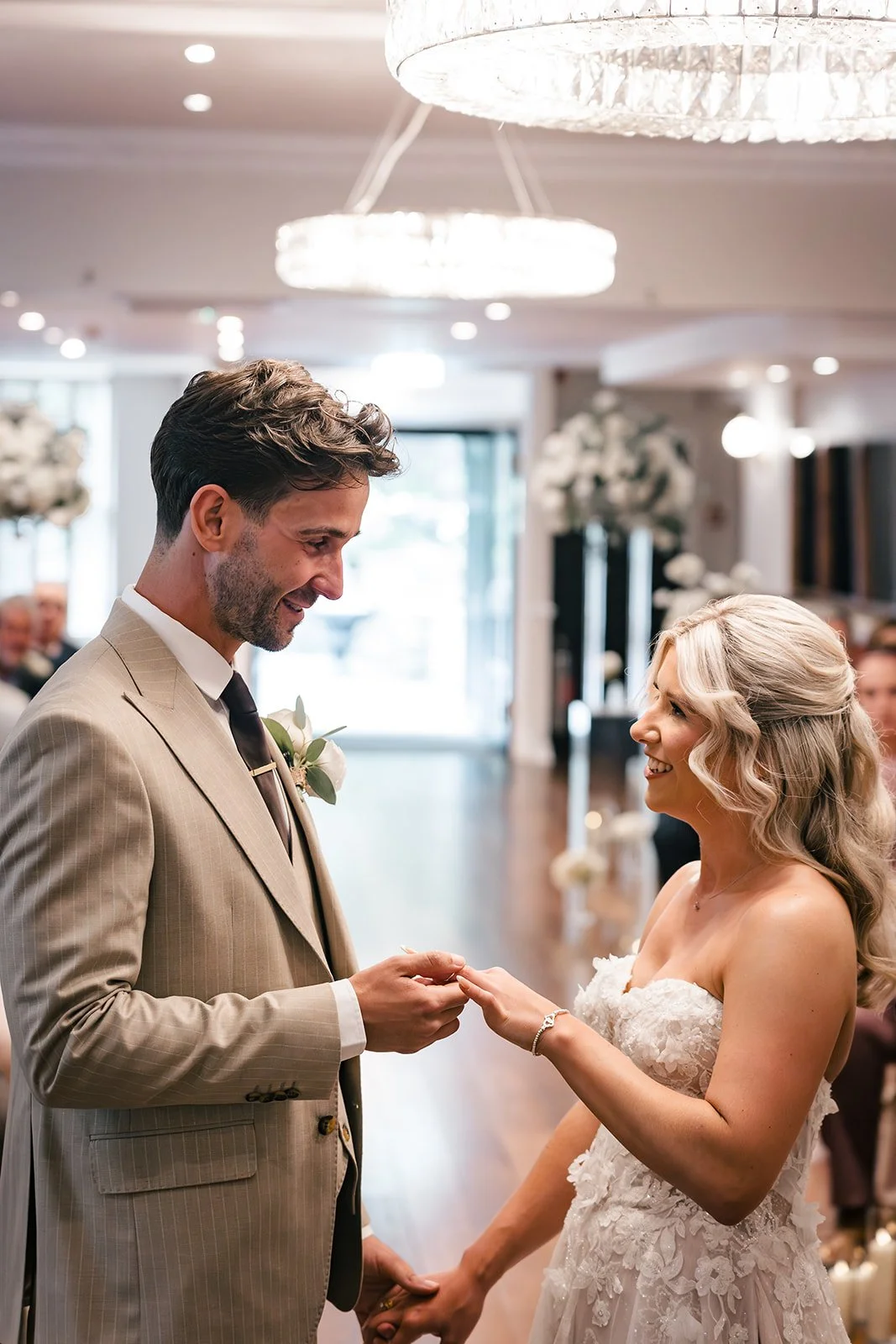 Bride placing ring on groom during ceremony at Sparth House