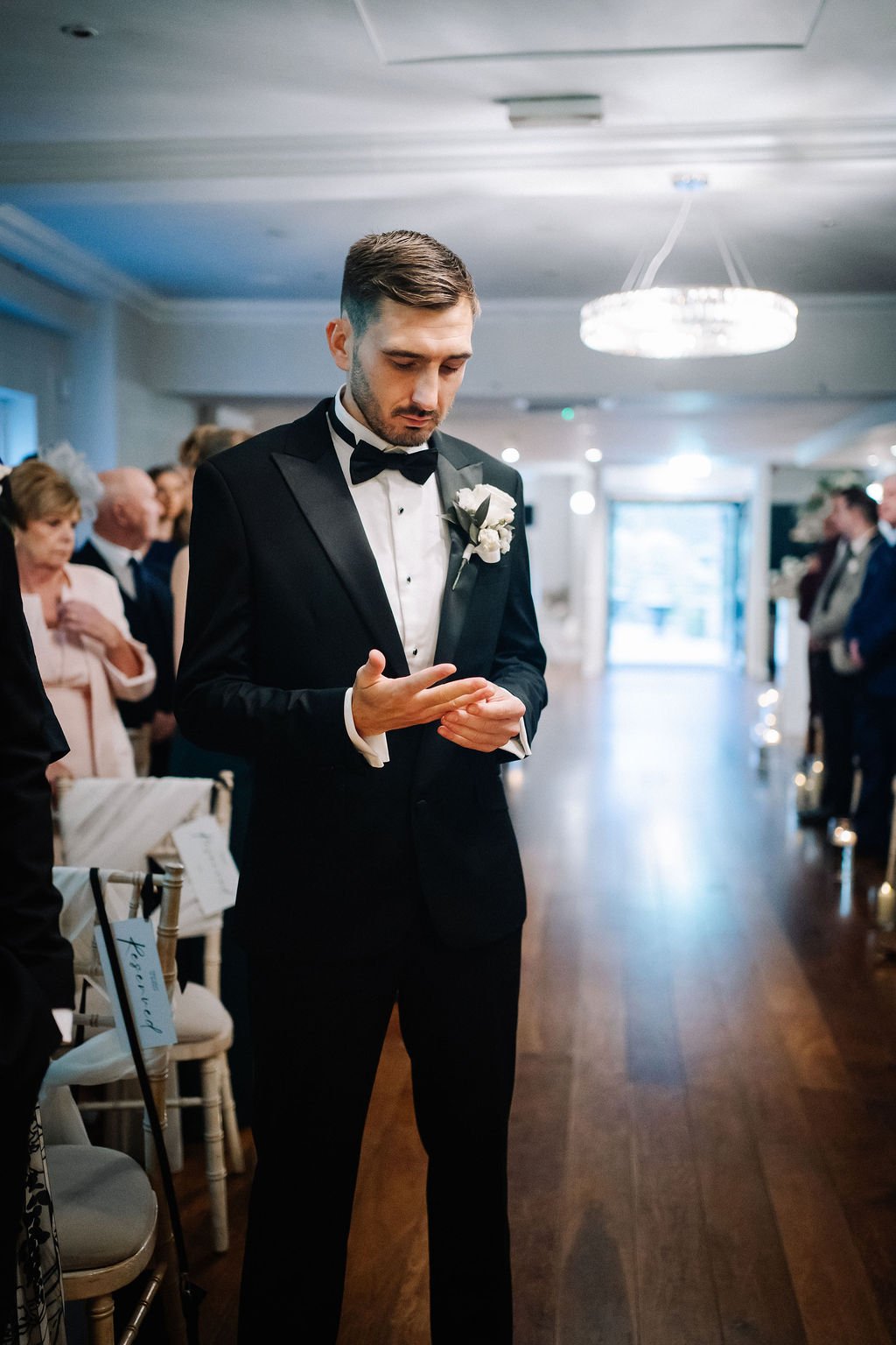 Groom waiting for Bride at the end of the aisle