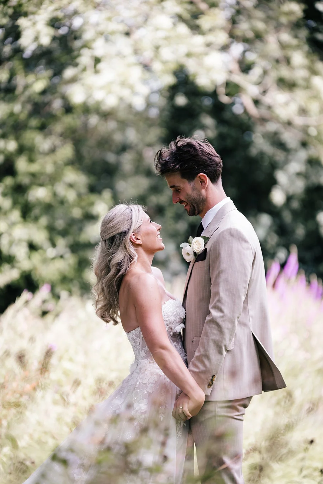 Bride smiling at groom during garden portraits at Sparth House