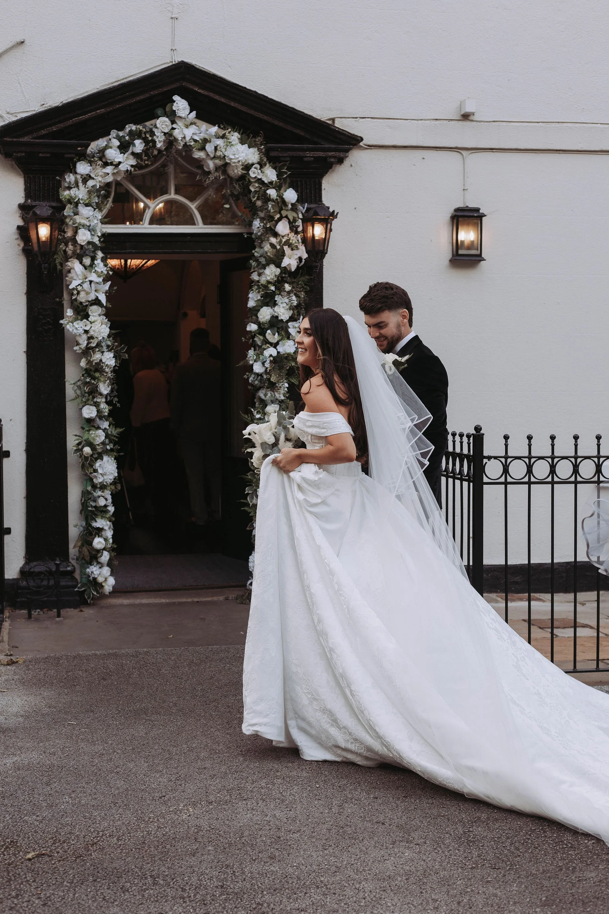Wedding couple walking through Sparth House iconic door