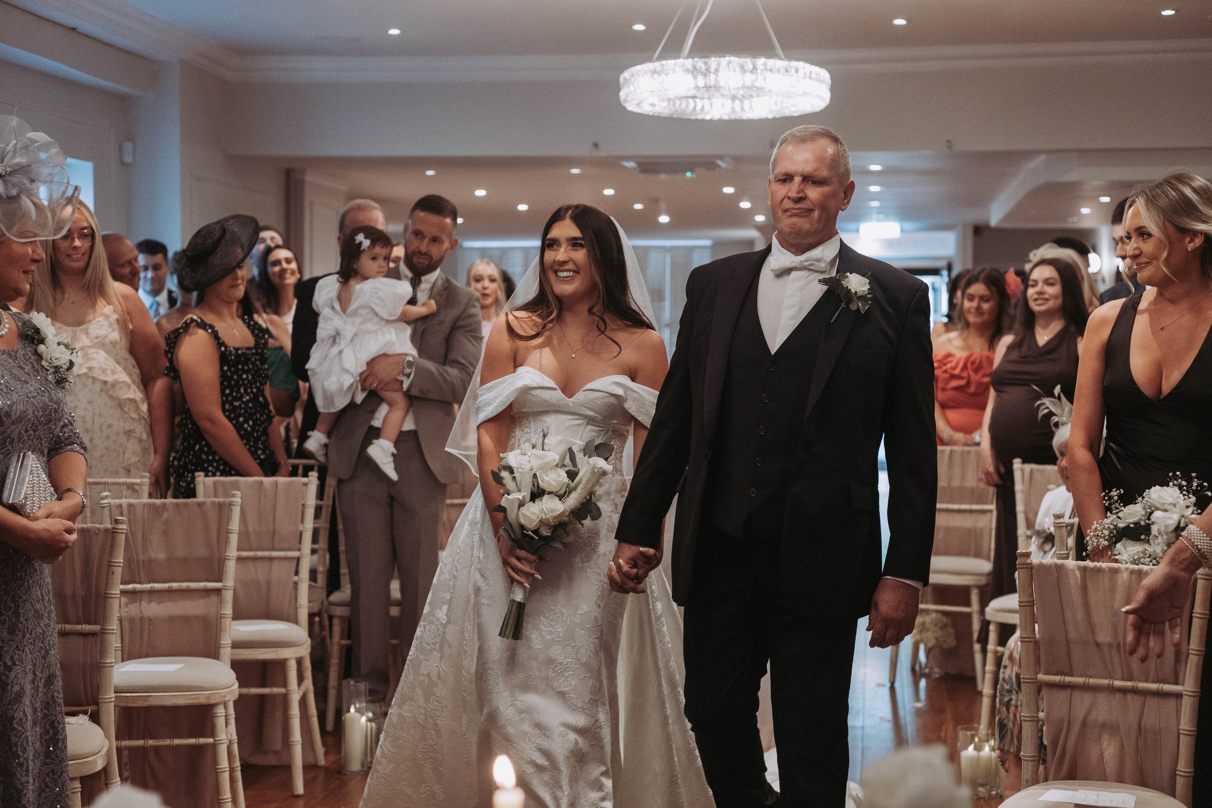 Father of bride and Bride walking down the aisle at Sparth House in lancashire