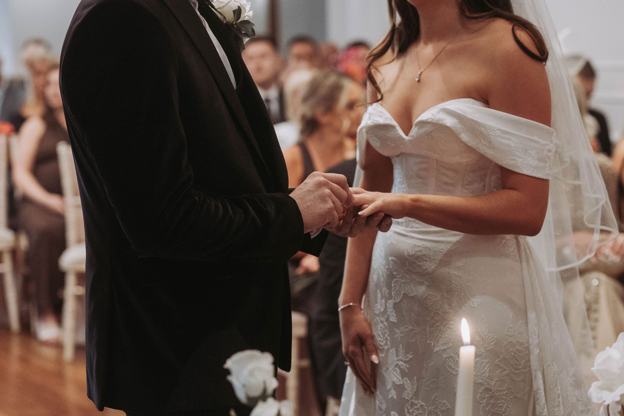 Bride and groom exchanging rings during ceremony at Sparth House wedding venue Lancashire