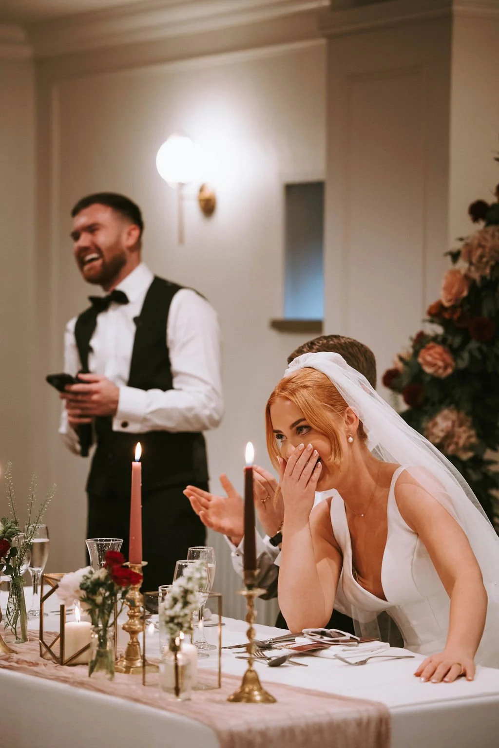 Bride laughing at best man speech