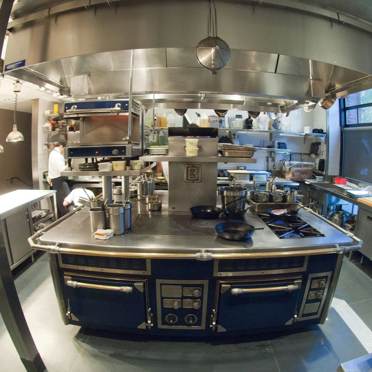 Chefs working in a kitchen designed by KRBS. 