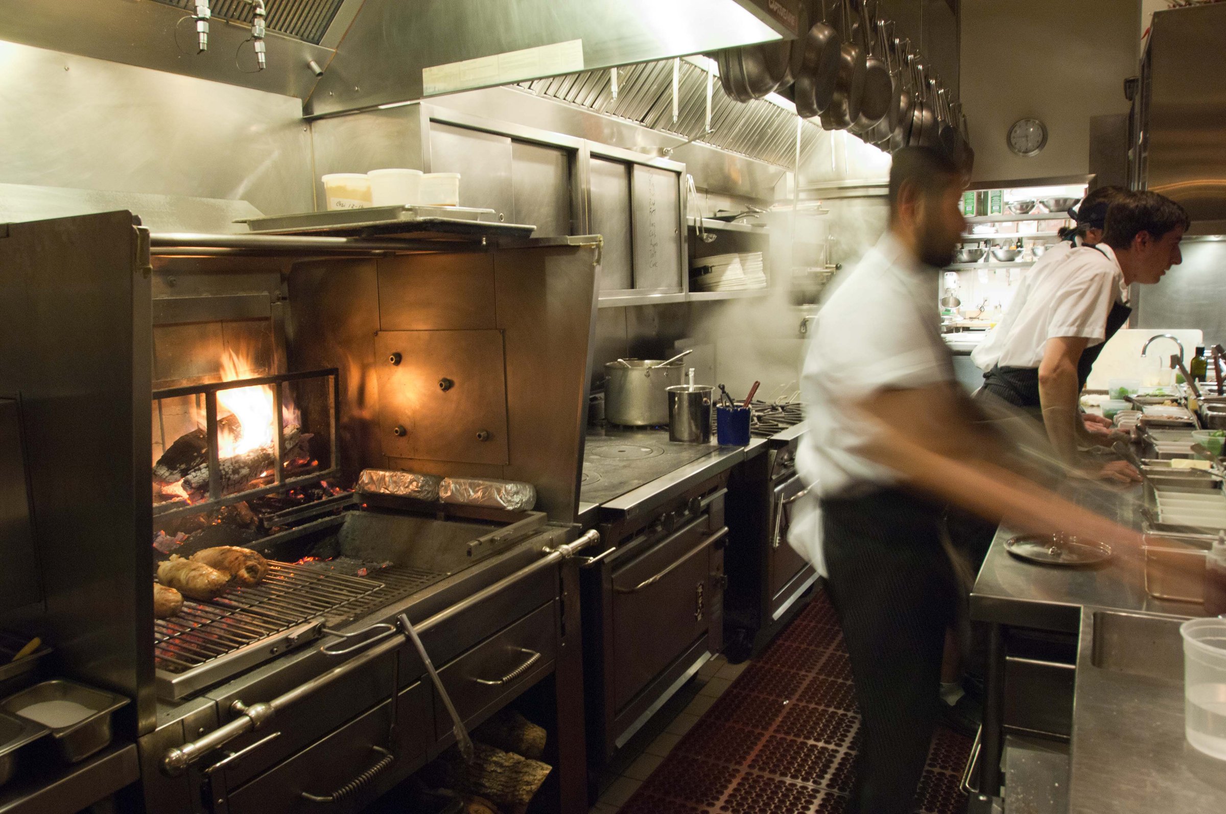Kitchen staff working in a space designed by KRBS. 