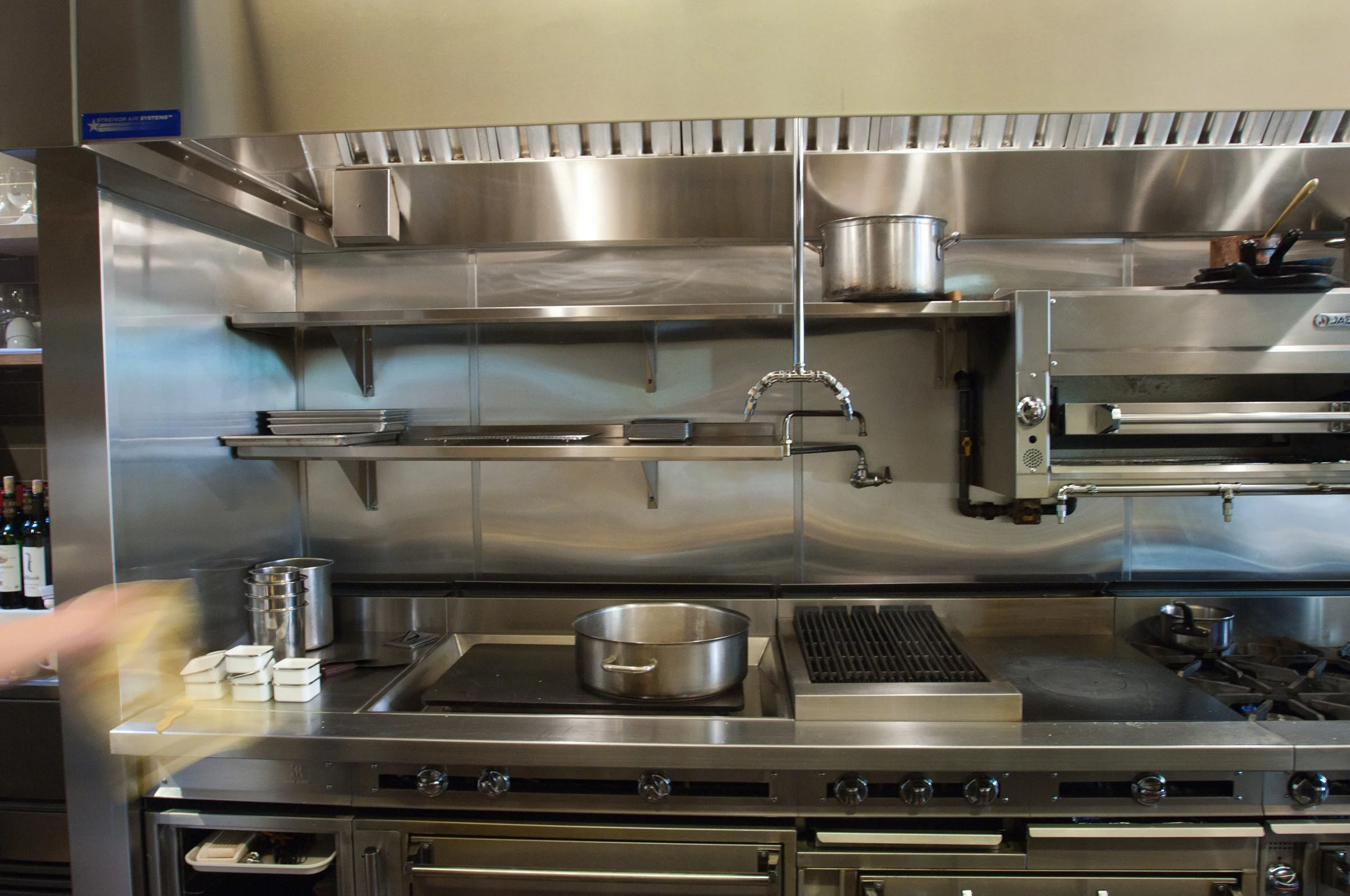 Stainless steel equipment in a kitchen designed by KRBS. 