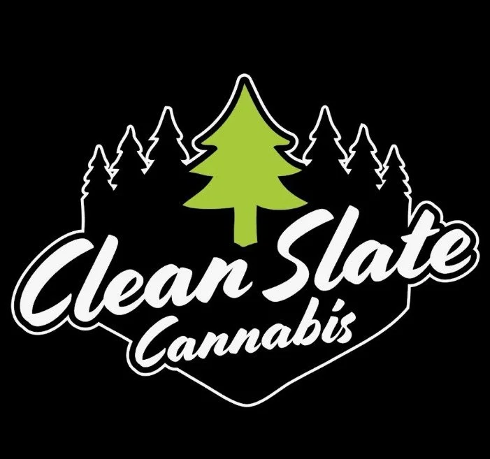 Logo with the words 'Clean Slate Cannabis' and a green cannabis leaf above a cluster of black pine trees on a black background.