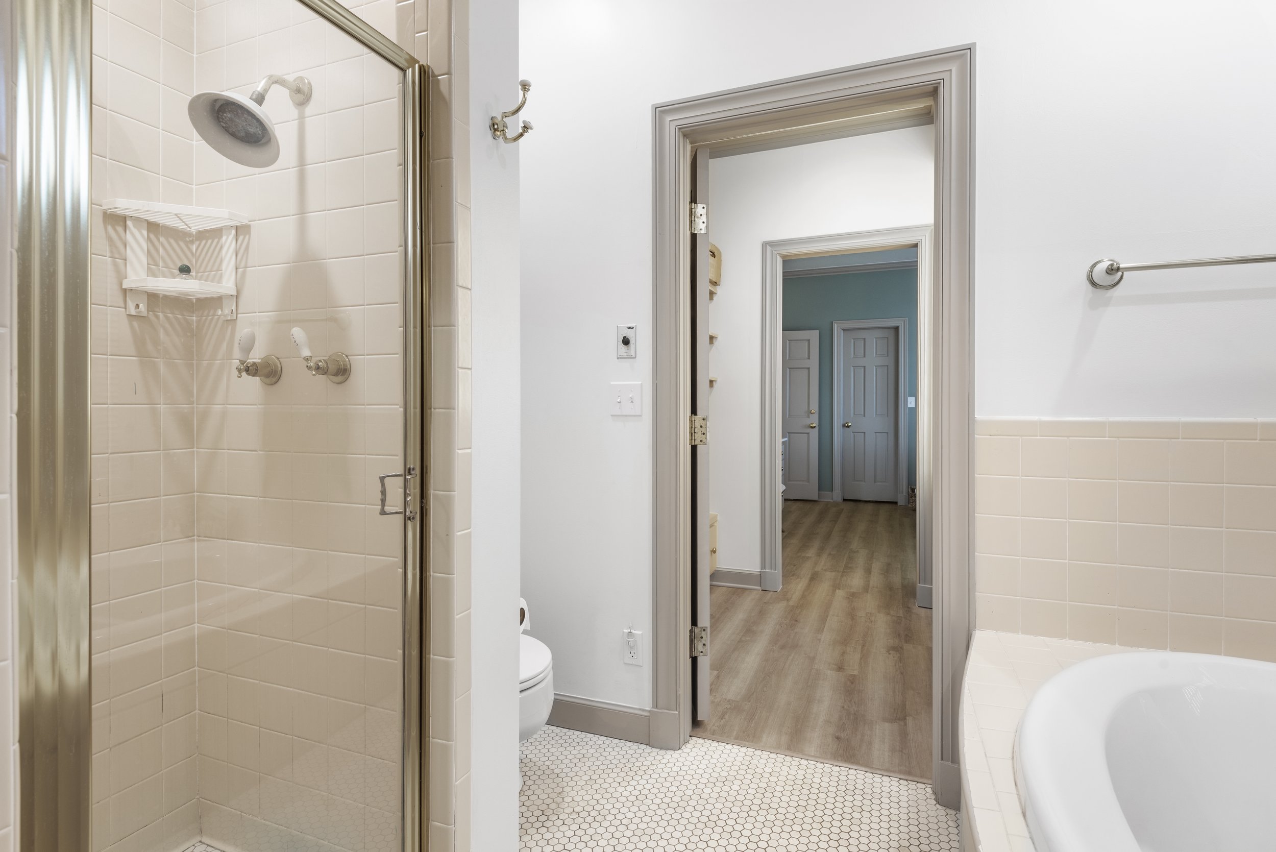 The bath has a jacuzzi style tube and stand alone shower.