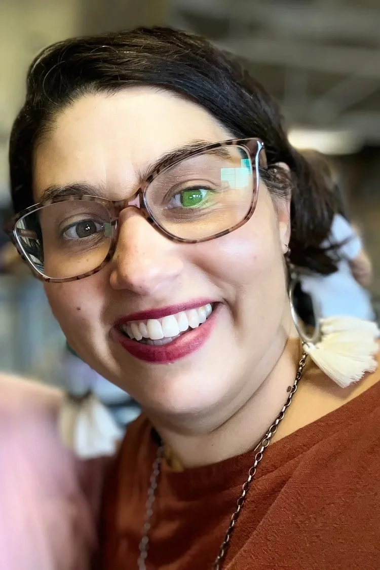 Madrone Phoenix smiling, wearing glasses.