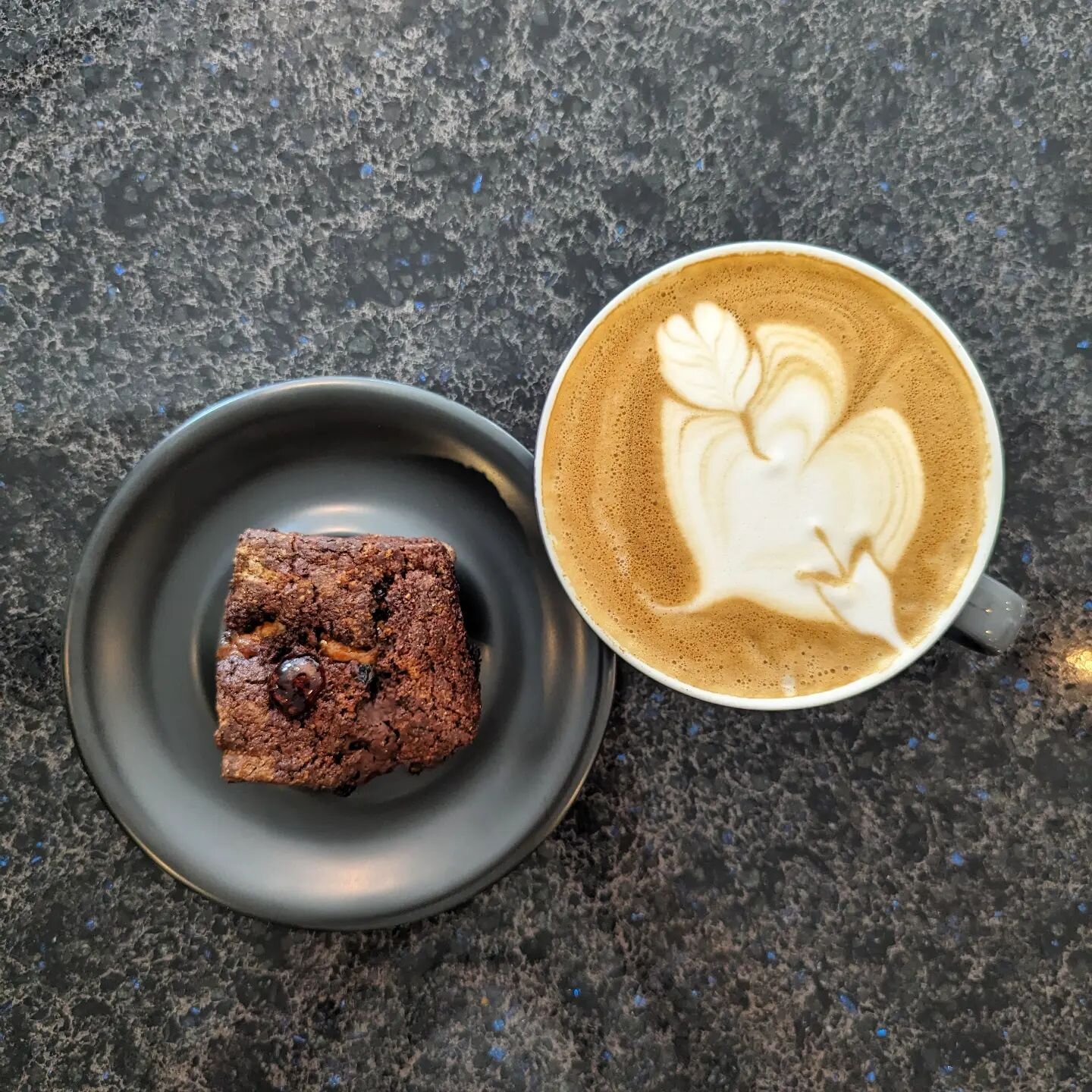 Lovely day for coffee, this natural process Kenyan from @blackwhiteroasters is just the tickets, sweet and rich in @rogers_farmstead milk. Also, today's @brotbakery treats include the Serious Chocolate Squares with rye sourdough. Happy VD. What did y