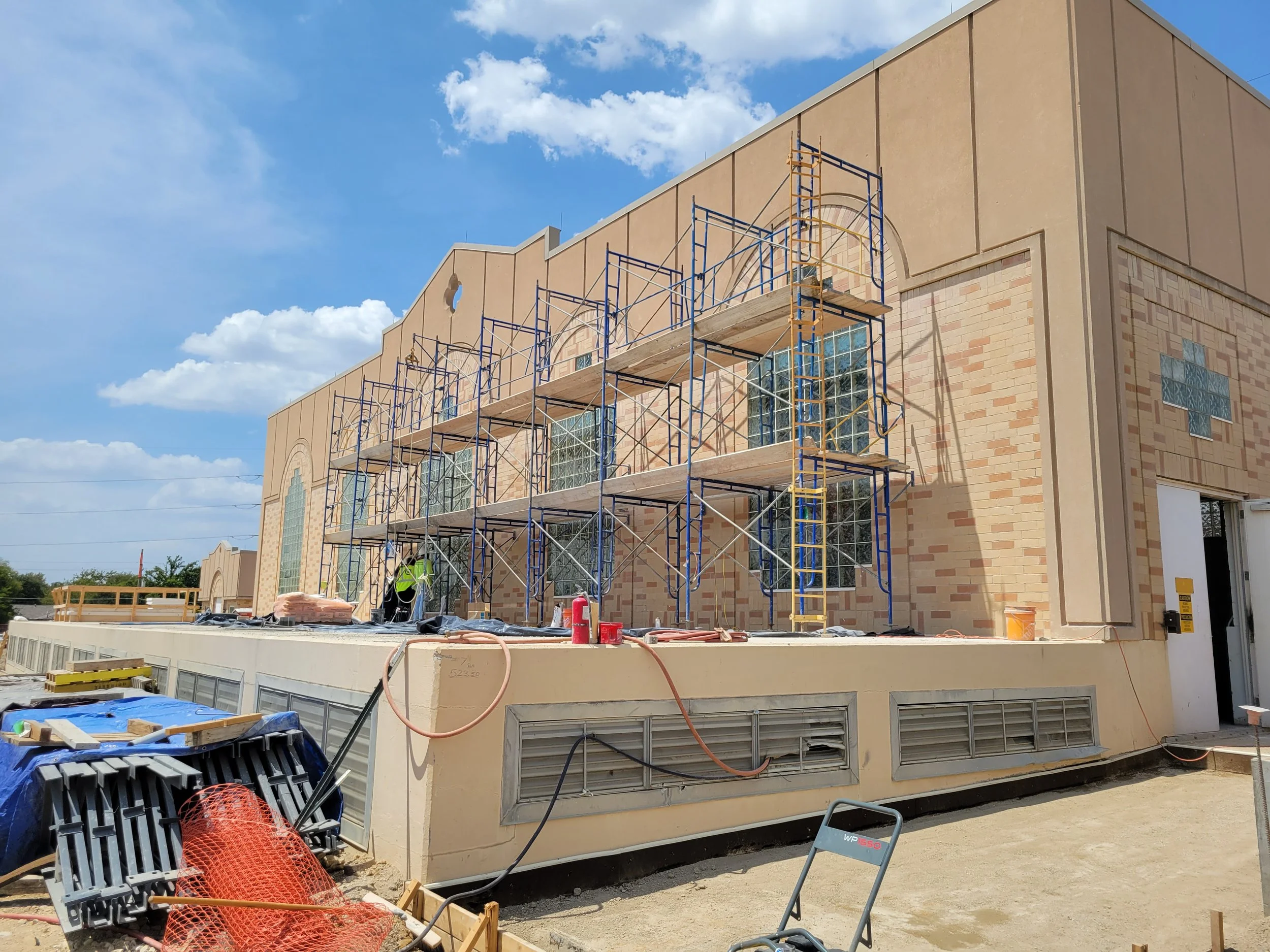 The outer façade of the existing pump station is undergoing brick repairs.