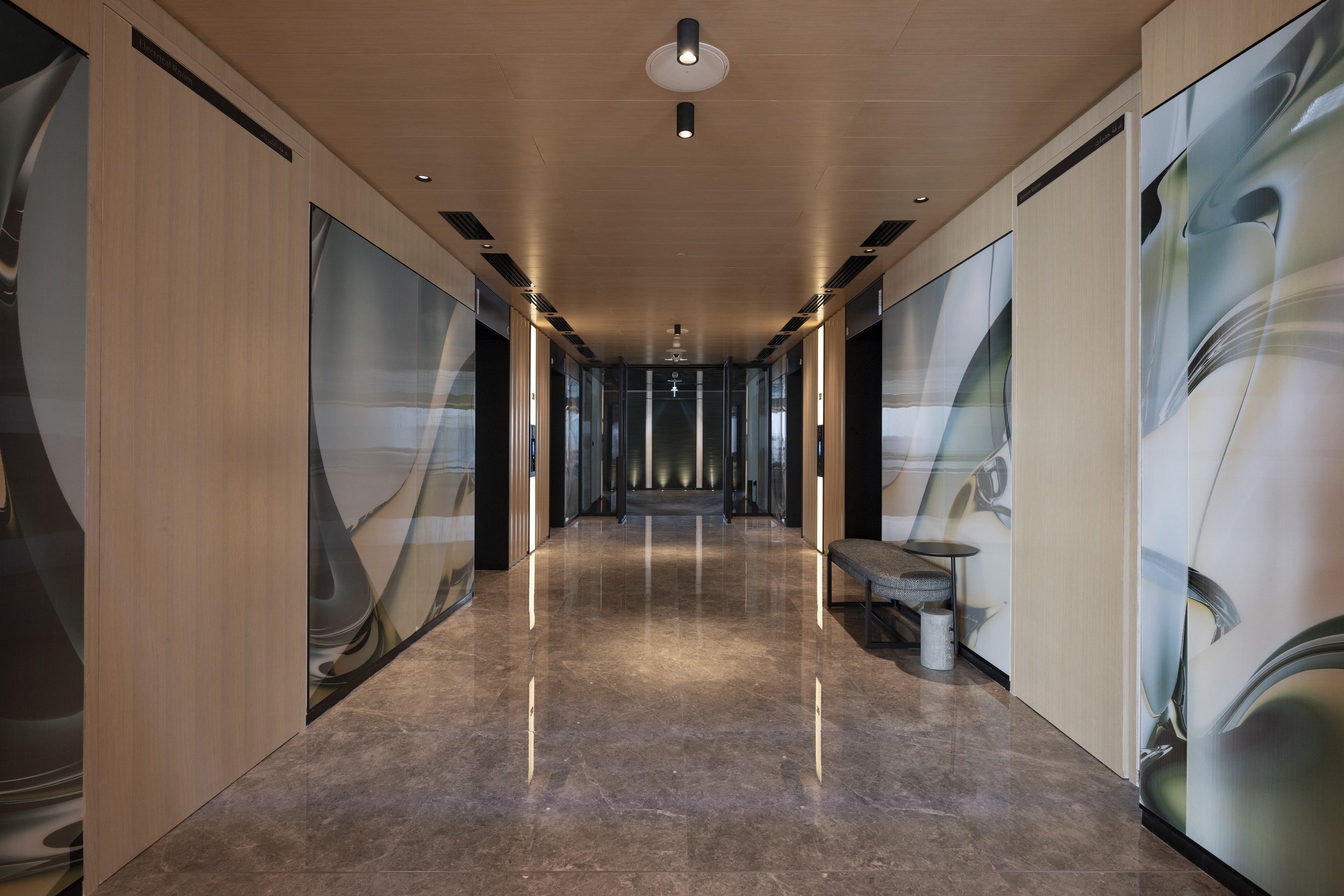A long hallway of alternating marbled and wood walls.