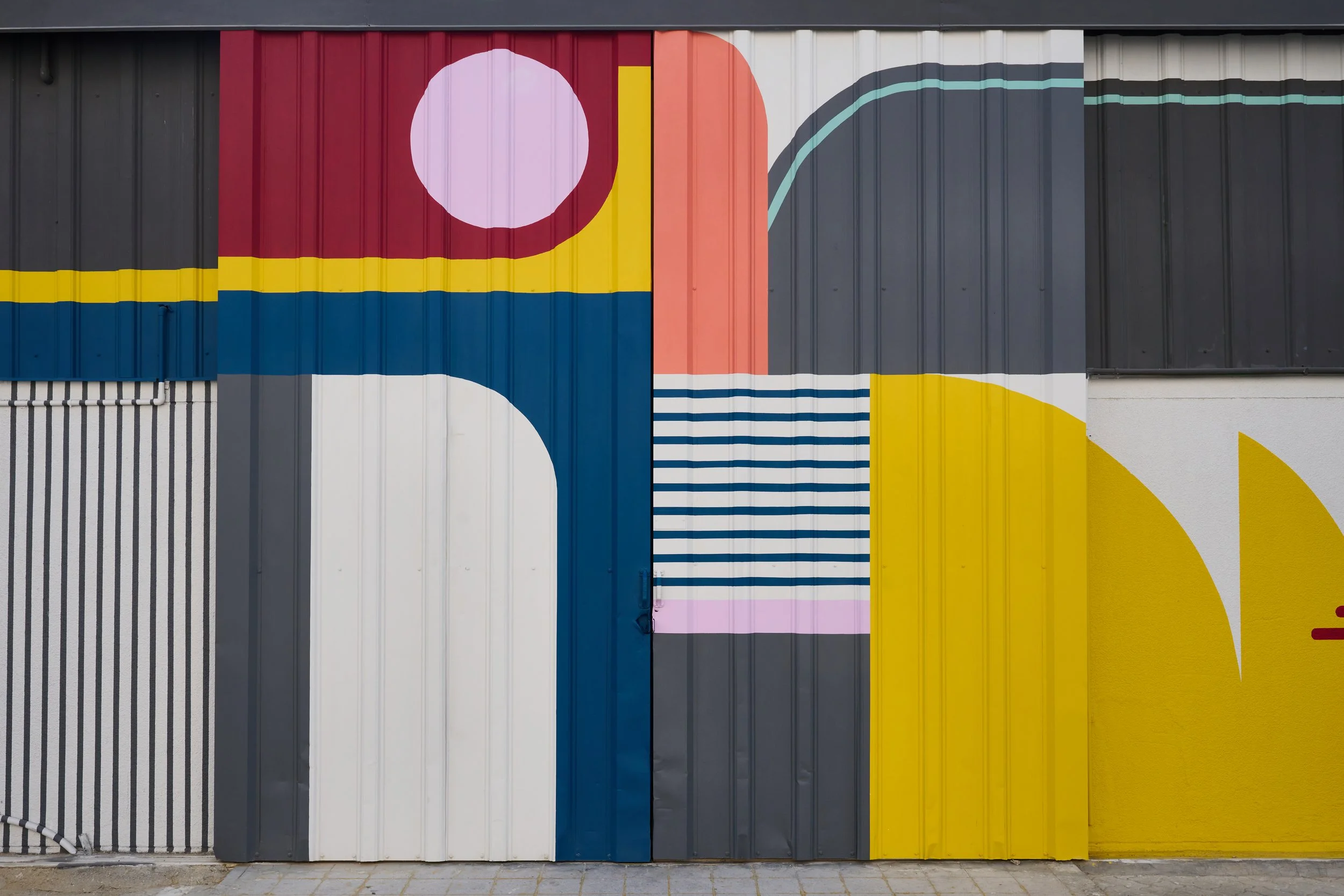 Large abstract geometric artwork on the front of hospitality art consultancy Capsule Arts.