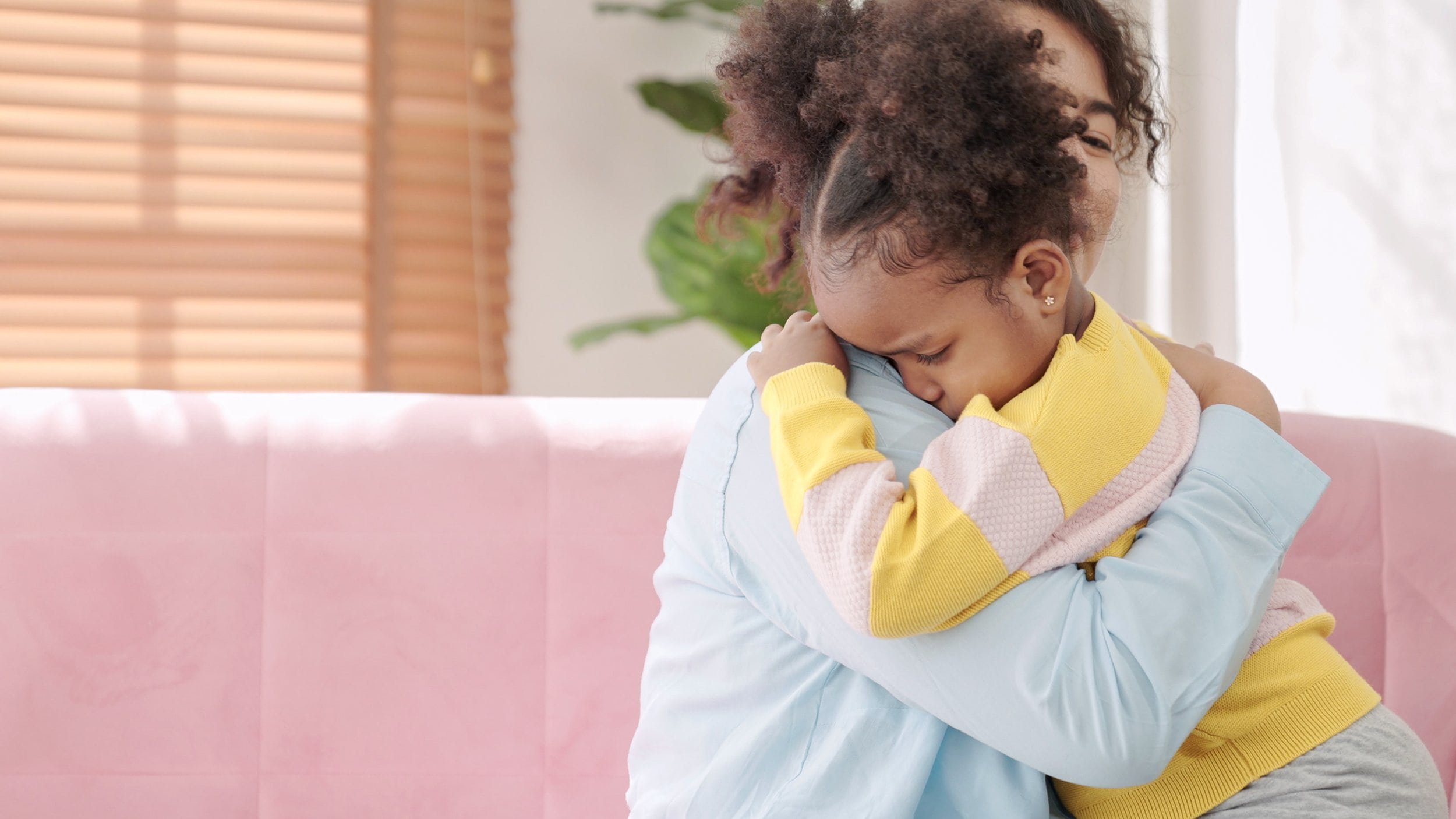 Black mother consoling her sad daughter