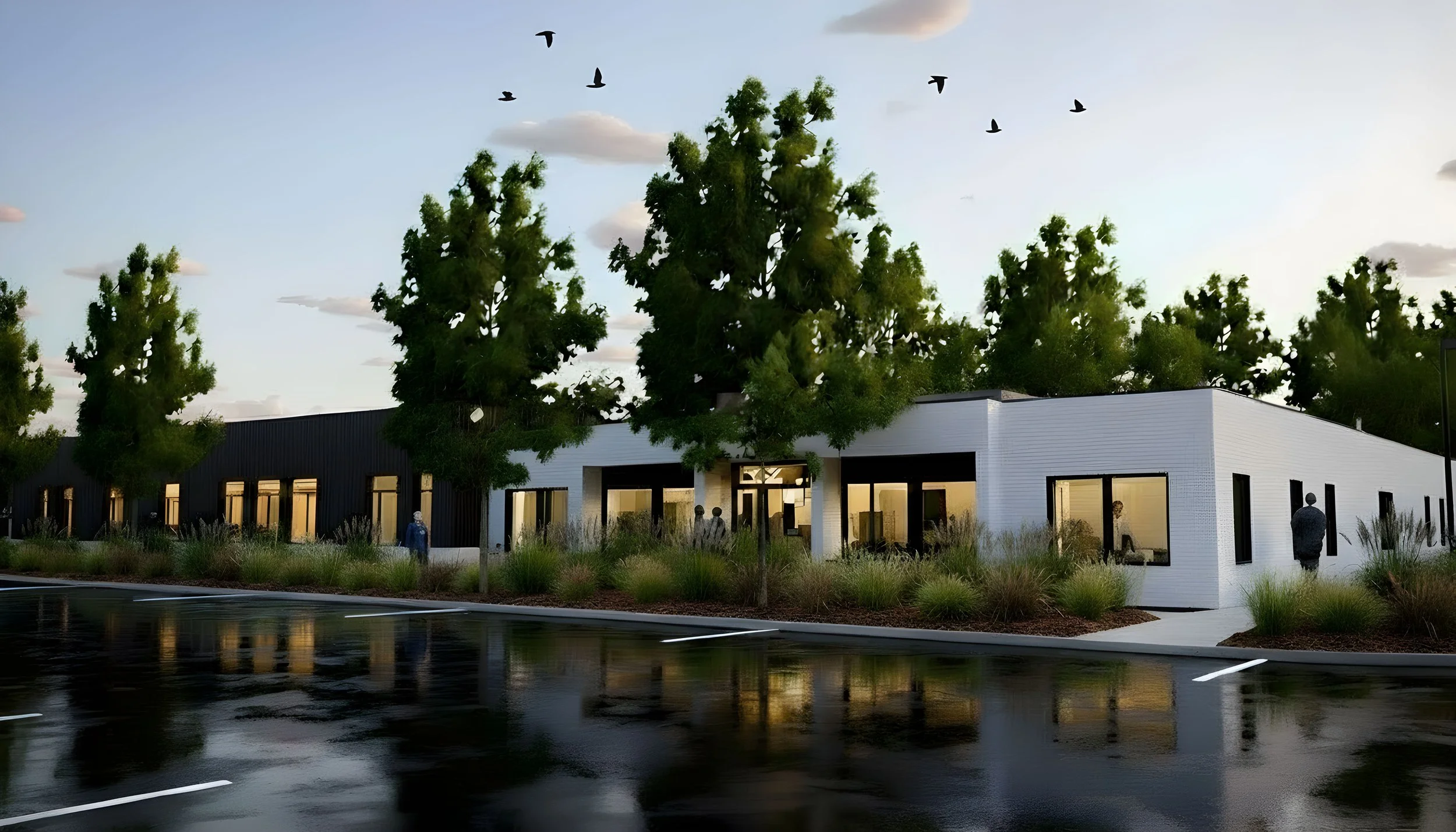 Architectural rendering of a modern, single-story building with large windows, surrounded by trees and landscaped with grasses, during dusk with a wet parking lot in the foreground and a flock of birds flying in the sky.