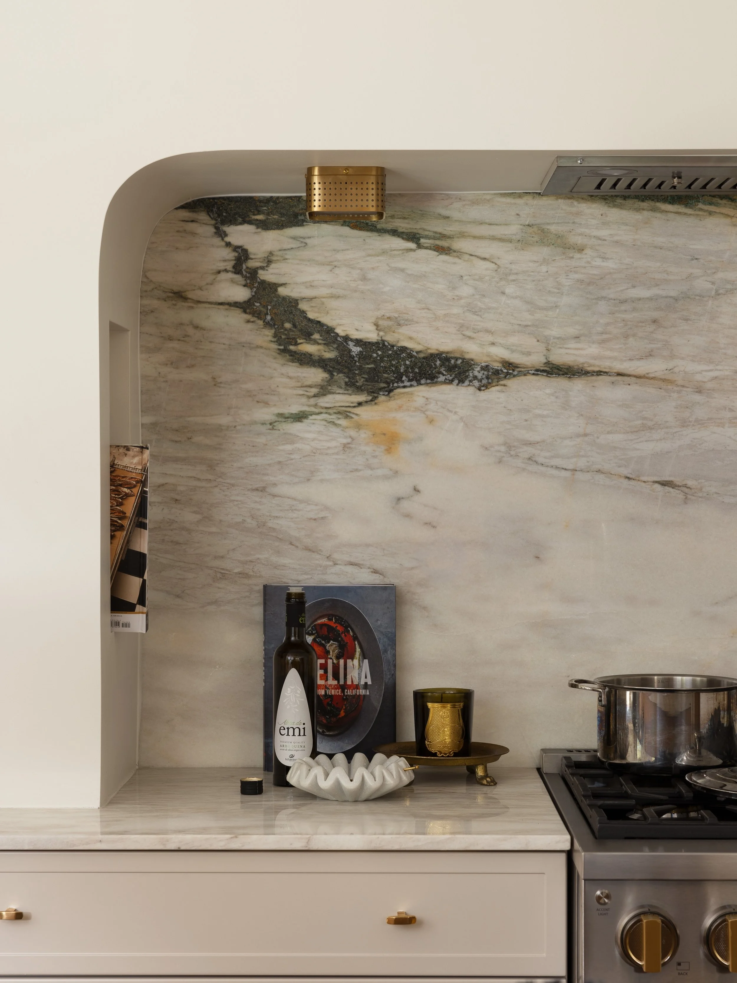 &bull; Inspired by European design, this range alcove is focal point of the kitchen. While simple in form, it instantly elevates the space, adds depth, and subtly frames a slab backsplash of rare Turkish marble. 

Our client&rsquo;s most utilized spa