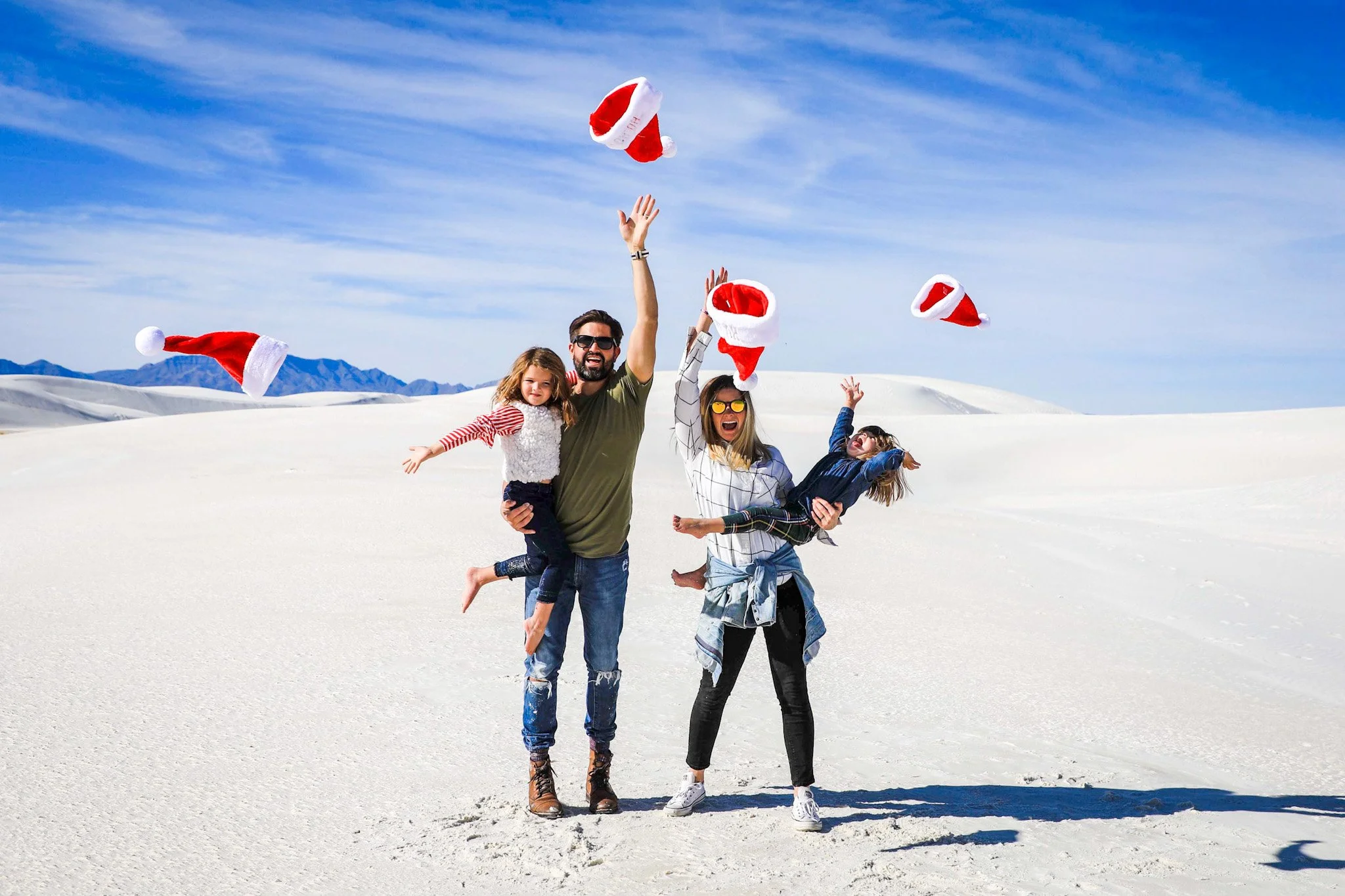 Judge family throwing santa hats on RV trip in New Mexico. 