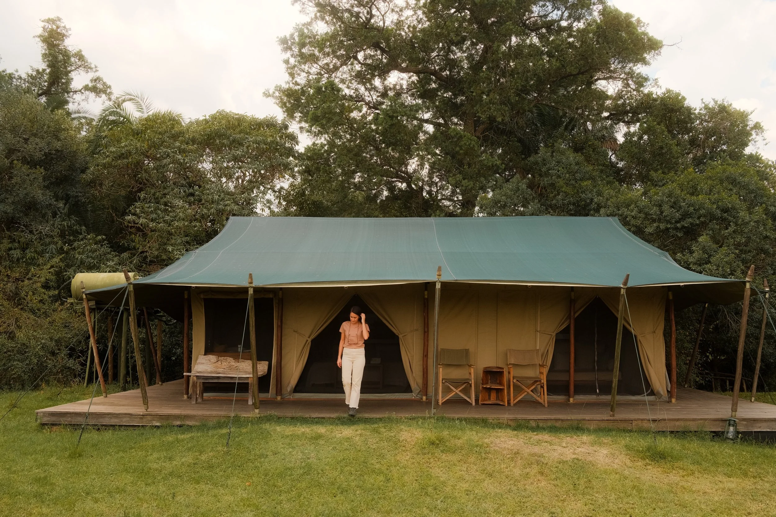 enkewa-safari-camp-masai-mara-kenya-luxury-tent-exterior-woman-doorway-wooden-deck-hospitality-photography-04.jpg