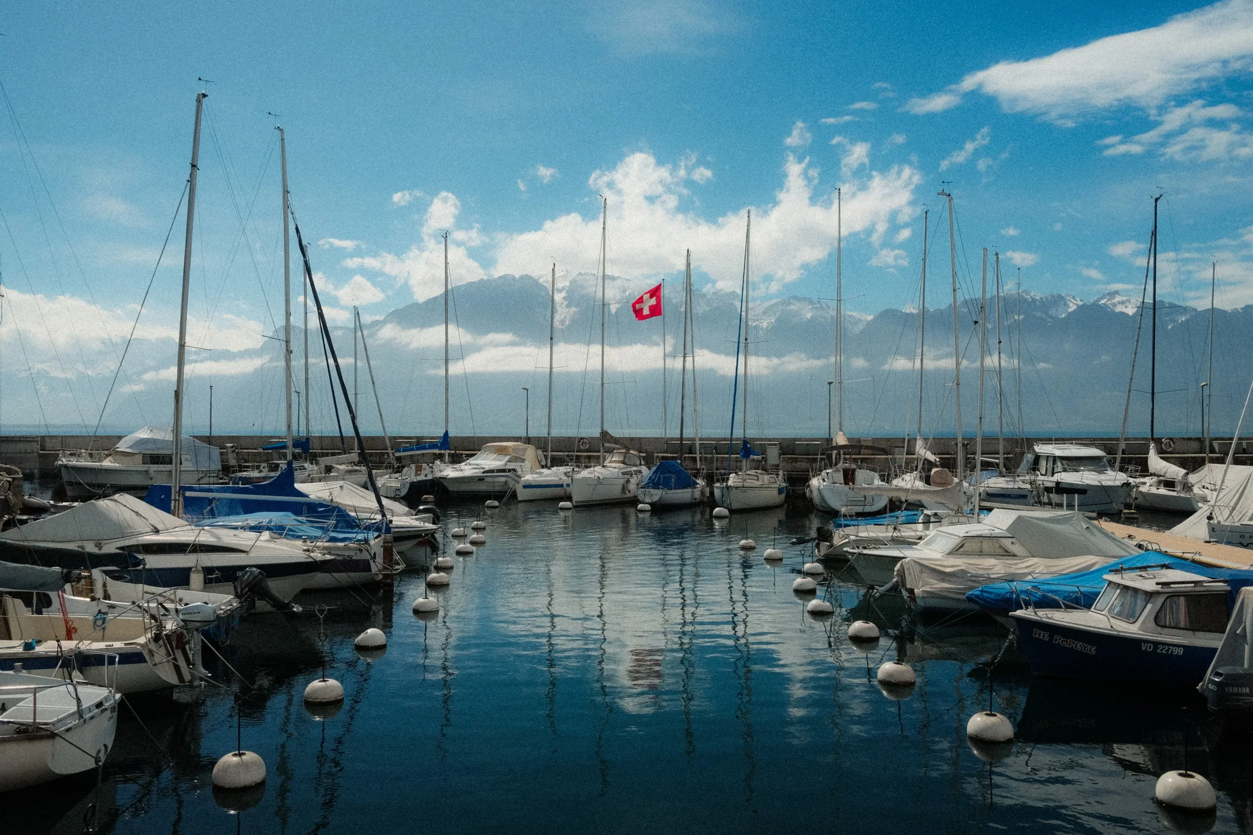 lake-geneva-switzerland-marina-sailboats-swiss-flag-alps-travel-photography-41.jpg