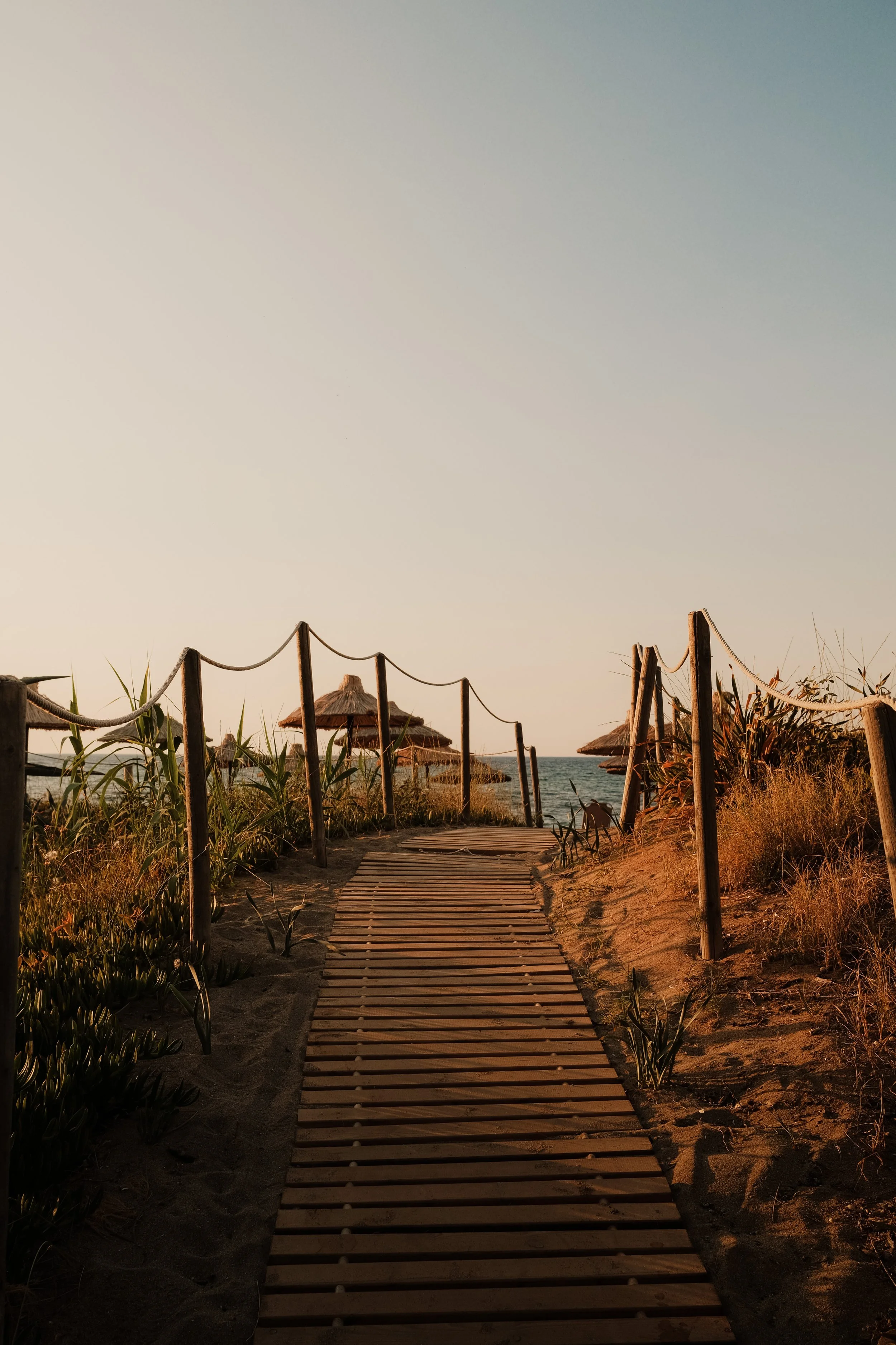 agapi-beach-resort-crete-greece-beach-boardwalk-dunes-straw-umbrellas-sea-golden-hour-hospitality-photography-19.jpg