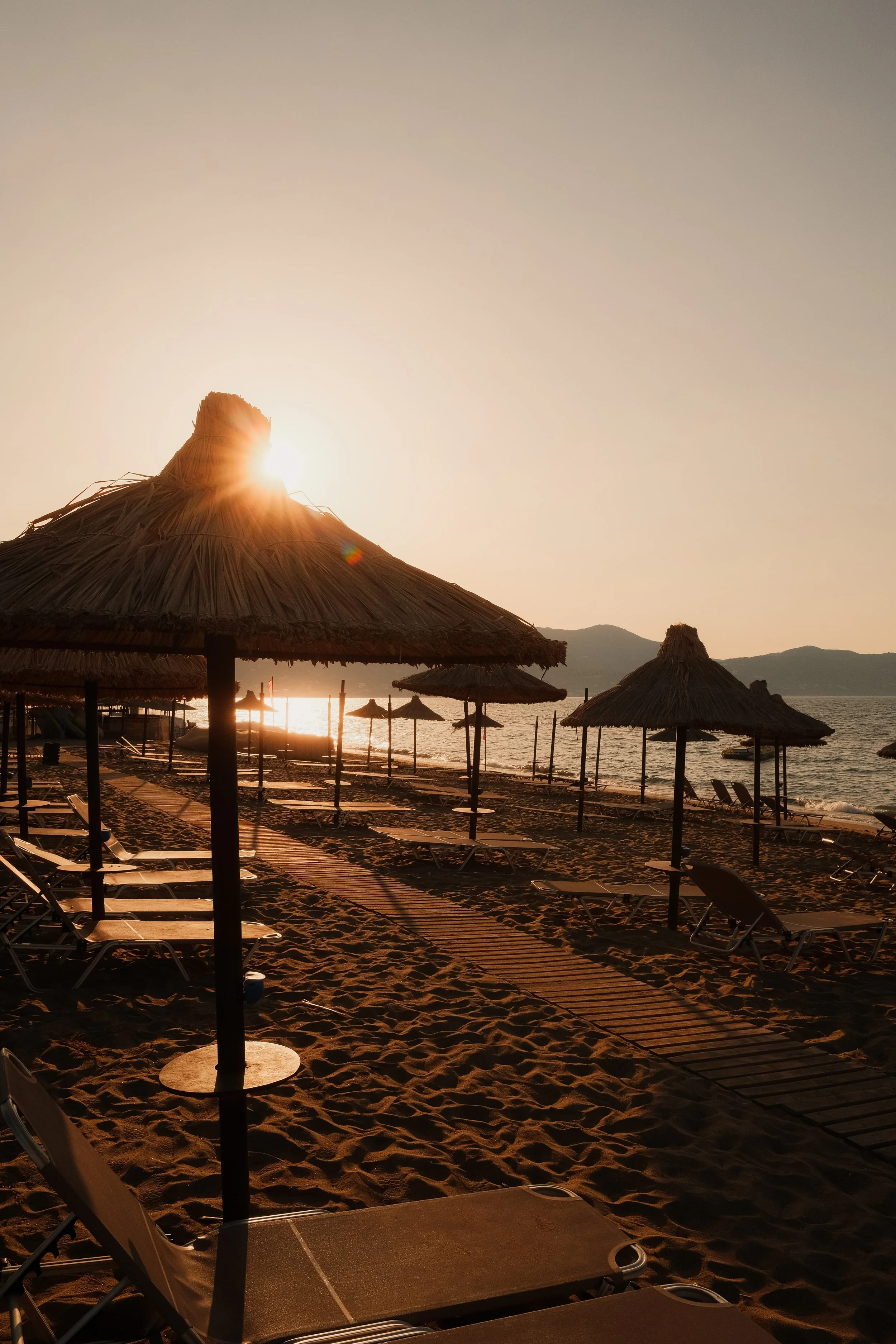 agapi-beach-resort-crete-greece-beach-straw-umbrellas-lounge-chairs-golden-sunset-mountain-hospitality-photography-14.jpg
