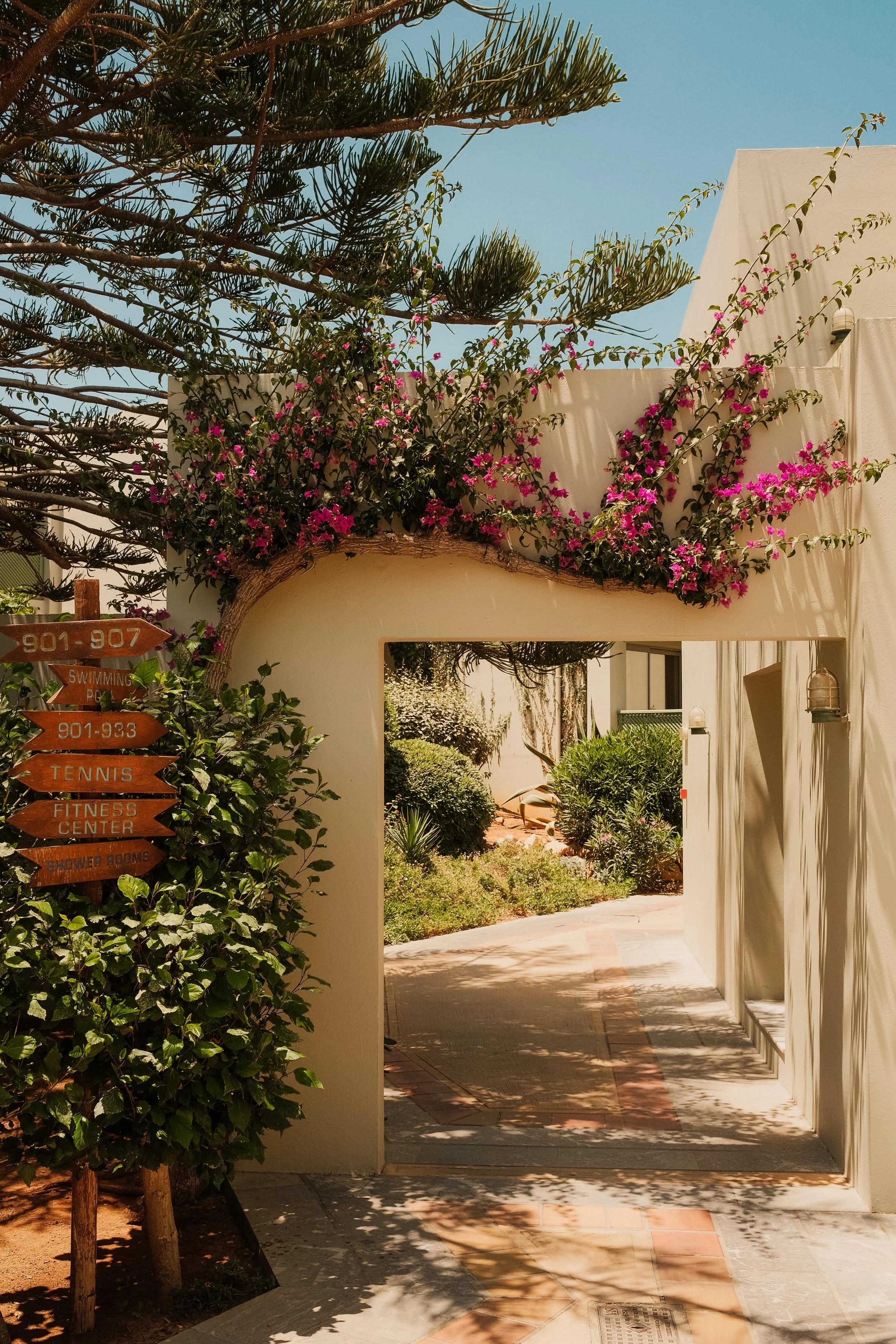 agapi-beach-resort-crete-greece-hotel-entrance-arch-bougainvillea-directional-signs-hospitality-photography-05.jpg