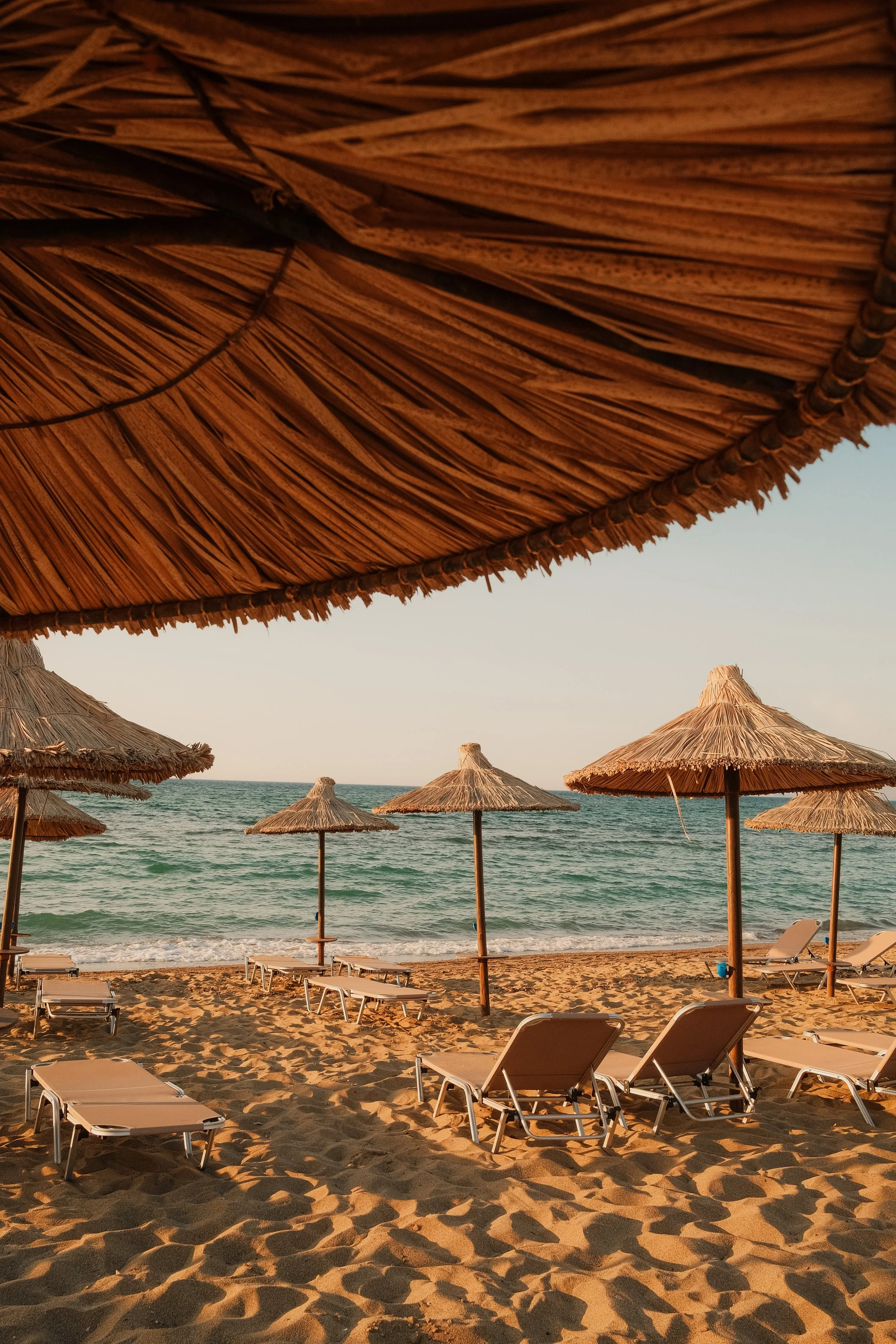 agapi-beach-resort-crete-greece-beach-straw-umbrellas-loungers-sea-summer-hospitality-photography-18.jpg